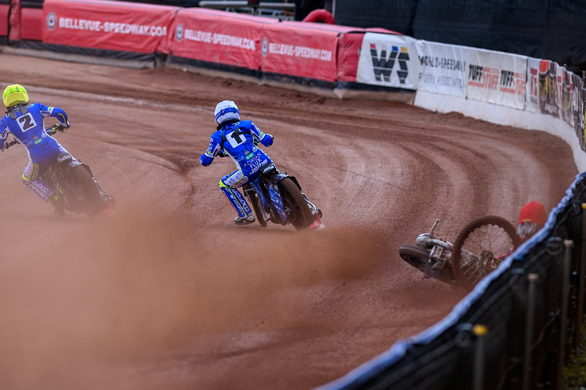 Belle Vue Colts' William Cairns falls whilst trying to pass Oxford Chargers' Jody Scott  in White and Oxford Chargers' Jacob Clouting  in Yellow during the WSRA National Development League match between Belle Vue Colts and Oxford Chargers at the National Speedway Stadium, Manchester on Sunday 1st June 2025. (Photo: Ian Charles | MI News)