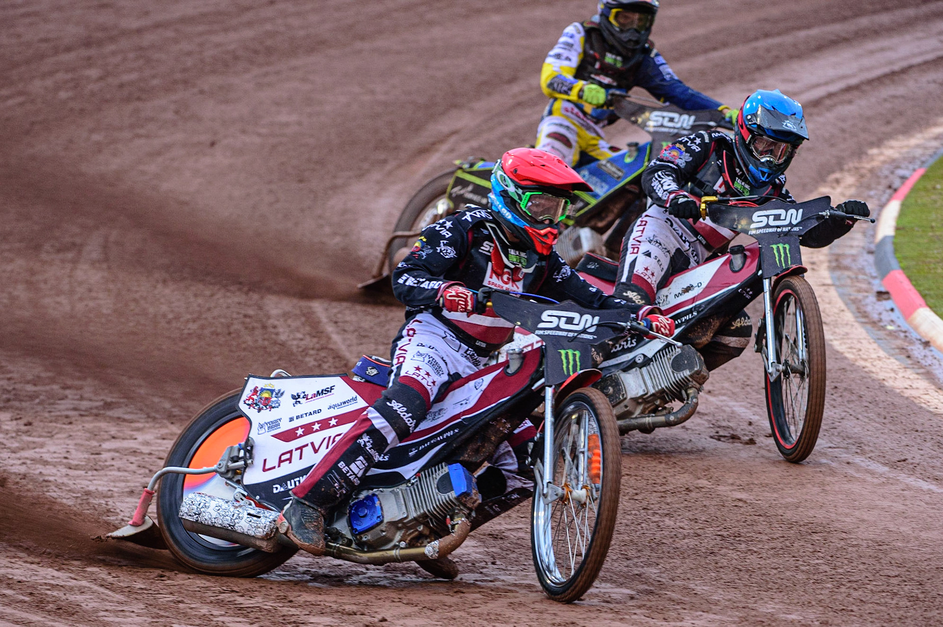 MANCHESTER, UK. OCT 17TH Andzejs Lebedevs of Latvia (Red) leads Olegs Mijailovs of Latvia and Philip Hellström-Bangs of Sweden (White) during the Monster Energy FIM Speedway of Nations at the National Speedway Stadium, Manchester on Sunday  17th October 2021. (Credit: Ian Charles | MI News)