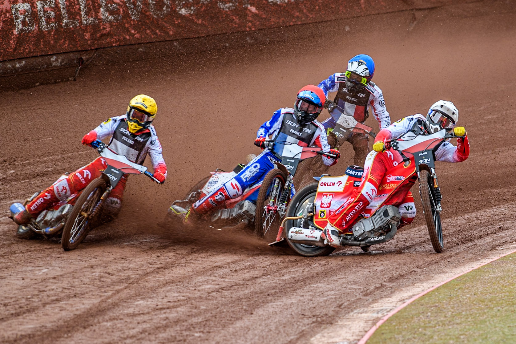 Poland v France: Dominik Kubera of Poland in White rides inside David Bellego of France in Red, Bartosz Zmarzlik of Poland in Yellow with Steven Goret of France in Blue at the rear during the Monster Energy FIM Speedway of Nations Semi-Final 1 at the National Speedway Stadium, Manchester on Tuesday 9th July 2024. (Photo: Ian Charles | MI News)