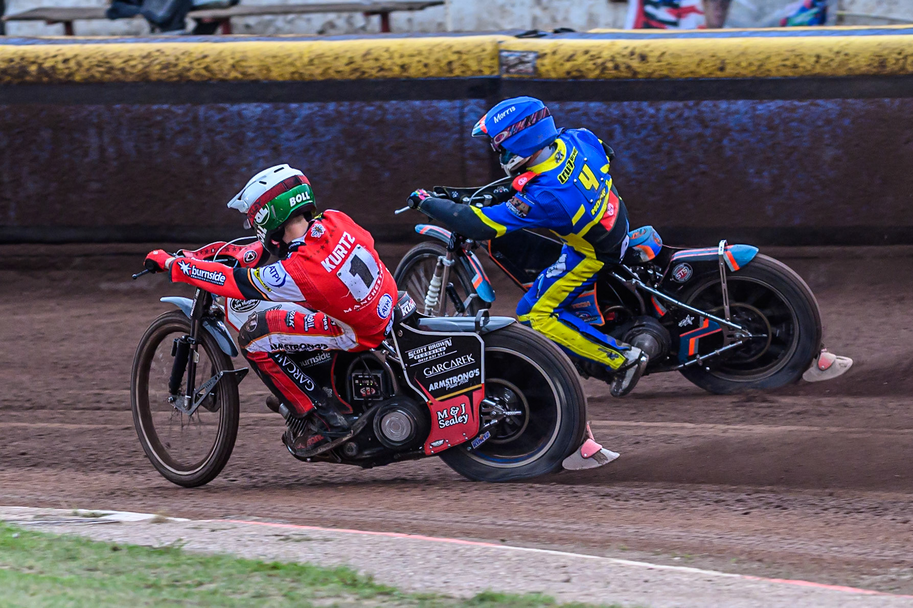 Brady Kurtz of Belle Vue Aces   in White passes Nick Morris of Sheffield Tigers  in Blue on their run to the line during the Rowe Motor Oil Premiership match between Sheffield Tigers and Belle Vue Aces at Owlerton Stadium, Sheffield on Monday 11th August 2025. (Photo: Ian Charles | MI News)