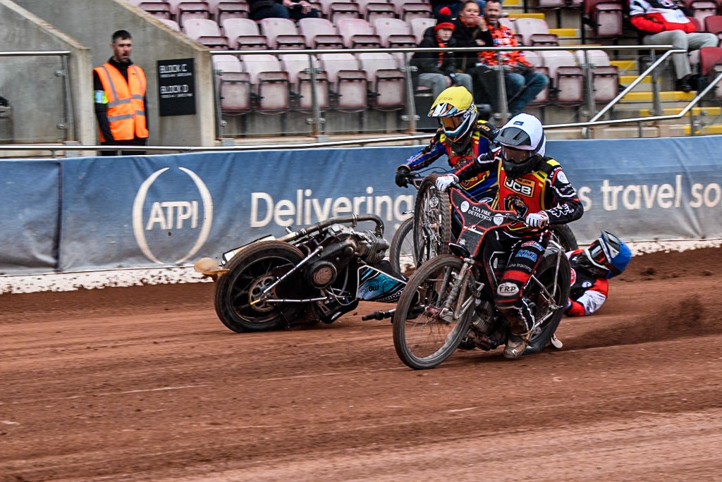 Belle Vue Colts' Harry Fletcher in Blue rears and falls between Leicester Lion Cubs' Guest Rider Ben Morley in White and Leicester Lion Cubs' Eli Meadows in Yellow during the WSRA National Development League match between Belle Vue Colts and Leicester Lion Cubs at the National Speedway Stadium, Manchester on Friday 18th April 2025. (Photo: Ian Charles | MI News)