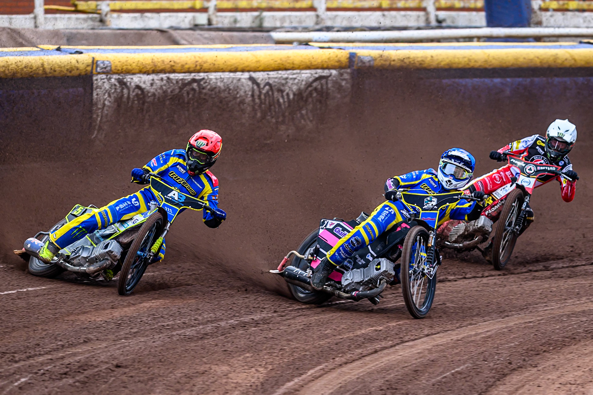 Chris Holder of Sheffield Tigers  in Red and Leon Flint of Sheffield Tigers  in Blue leading Dan Bewley of Belle Vue Aces   in White during the Rowe Motor Oil Premiership match between Sheffield Tigers and Belle Vue Aces at Owlerton Stadium, Sheffield on Monday 11th August 2025. (Photo: Ian Charles | MI News)