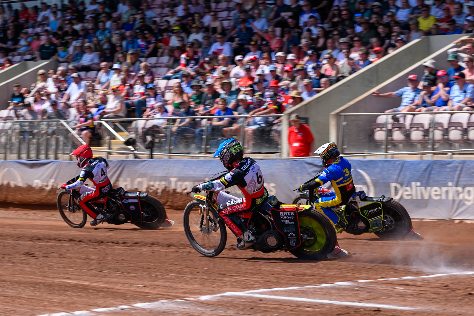 Tate Zischke of Belle Vue Aces in Blue chases Chris Holder of Sheffield Tigers in White and Zach Cook of Belle Vue Aces in Red during the Rowe Motor Oil Premiership match between Belle Vue Aces and Sheffield Tigers at the National Speedway Stadium, Manchester on Monday 25th May 2026. (Photo: Ian Charles | MI News)