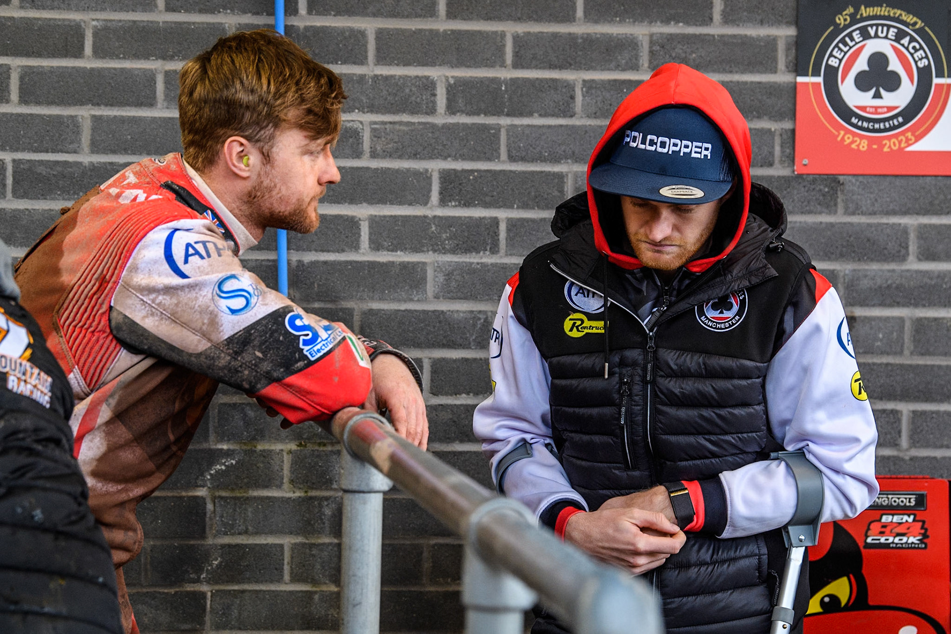 Belle Vue Aces' Connor Mountain (Left) with injured Aces rider Brady Kurtz during the Rowe Motor Oil Premiership match between Belle Vue Aces and Sheffield Tigers at the National Speedway Stadium, Manchester on Monday 27th May 2024. (Photo: Ian Charles | MI News)