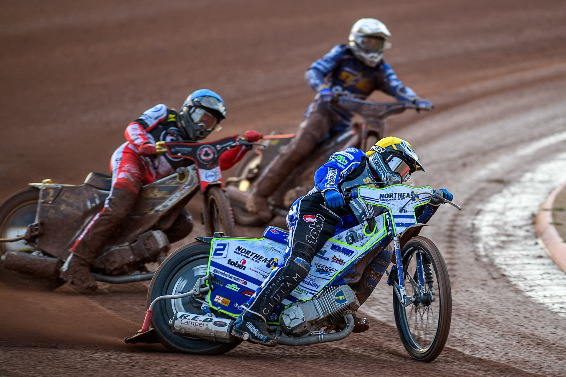 Kings Lynn Stars' Guest Rider Chris Harris  in Yellow leading Belle Vue Aces' Norick Blodorn  in Blue and Kings Lynn Stars' Jan Kvech  in White during the Rowe Motor Oil Premiership match between Belle Vue Aces and King's Lynn Stars at the National Speedway Stadium, Manchester on Monday 12th August 2024. (Photo: Ian Charles | MI News)