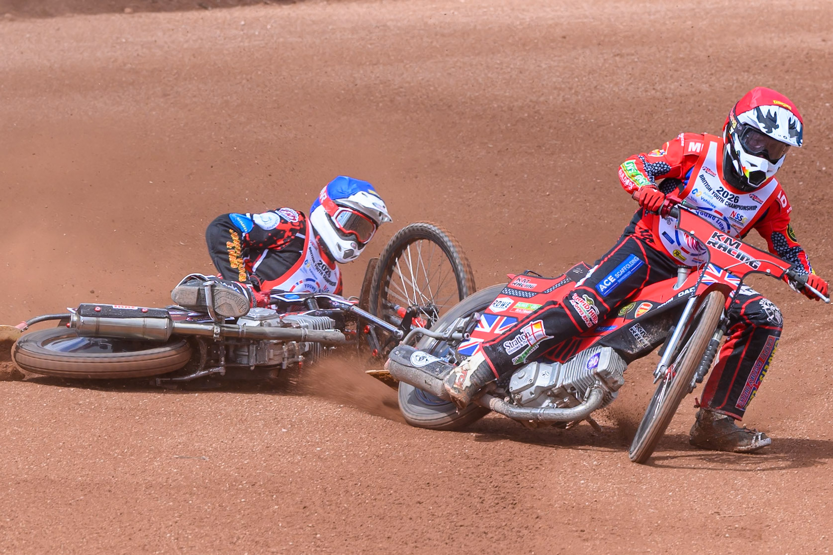 BRITISH YOUTH CHAMPIONSHIP (500cc): Kayden Mundy (8) in Red rides inside Dylan Huthwaite (9)  in Blue who then falls during the British Youth Speedway Championship at the National Speedway Stadium, Manchester on Sunday 10th May 2026. (Photo: Ian Charles | MI News)