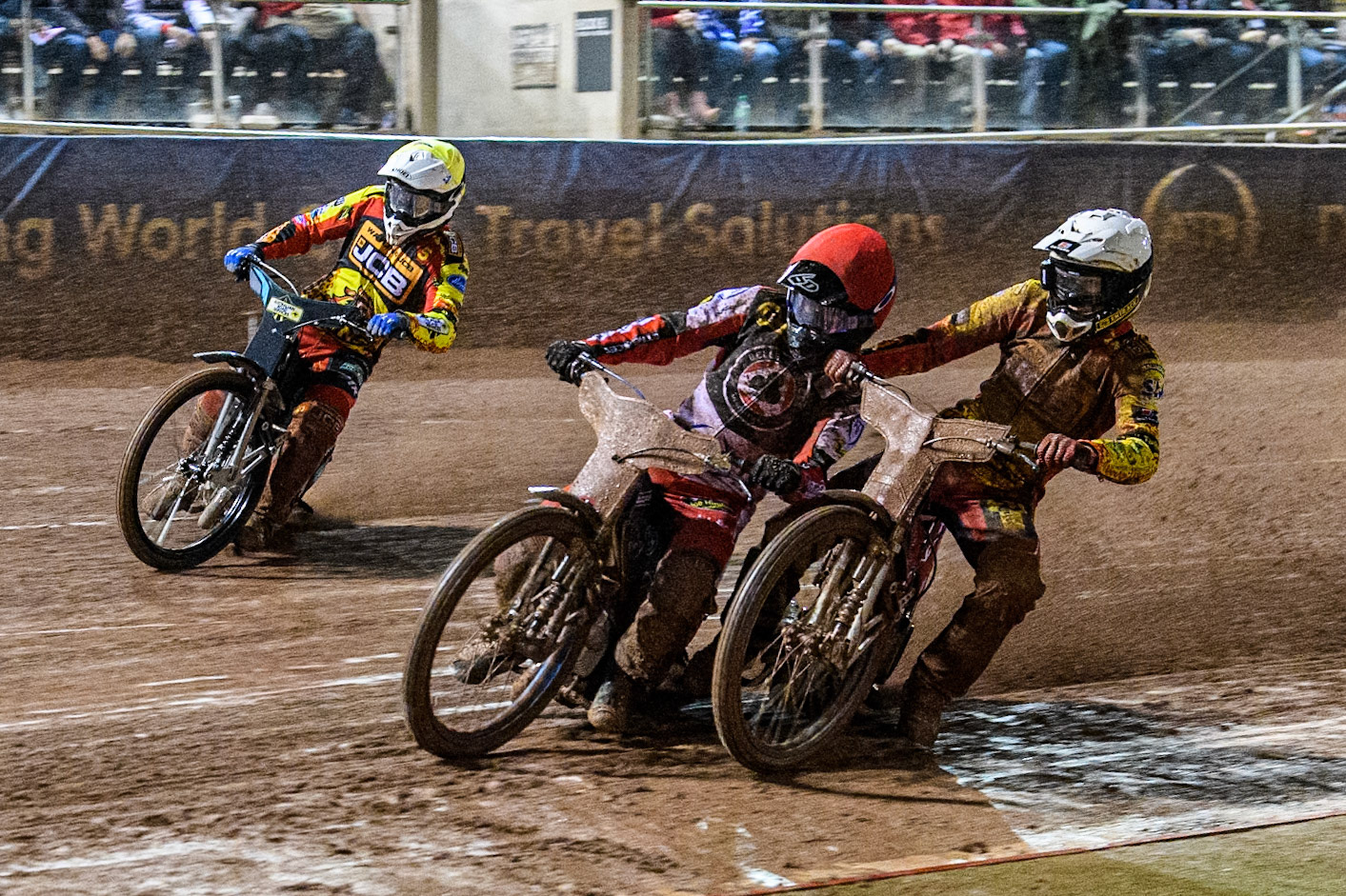 Leicester Lions' Max Fricke  in White and Belle Vue Aces' Brady Kurtz  in Red get a bit close with Leicester Lions' Ryan Douglas  in Yellow behind during the Rowe Motor Oil Premiership Grand Final 1st Leg between Belle Vue Aces and Leicester Lions at the National Speedway Stadium, Manchester on Monday 23rd September 2024. (Photo: Ian Charles | MI News)
