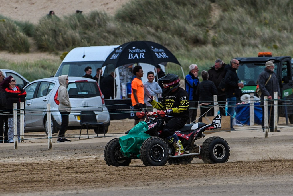 Dan Bray (240) celebrates winning the Quads Final during the Fylde ACU British Sand Racing Masters Championship at  St Annes on Sea, Lancashire on Sunday 30th July 2023. (Photo: Ian Charles | MI News)