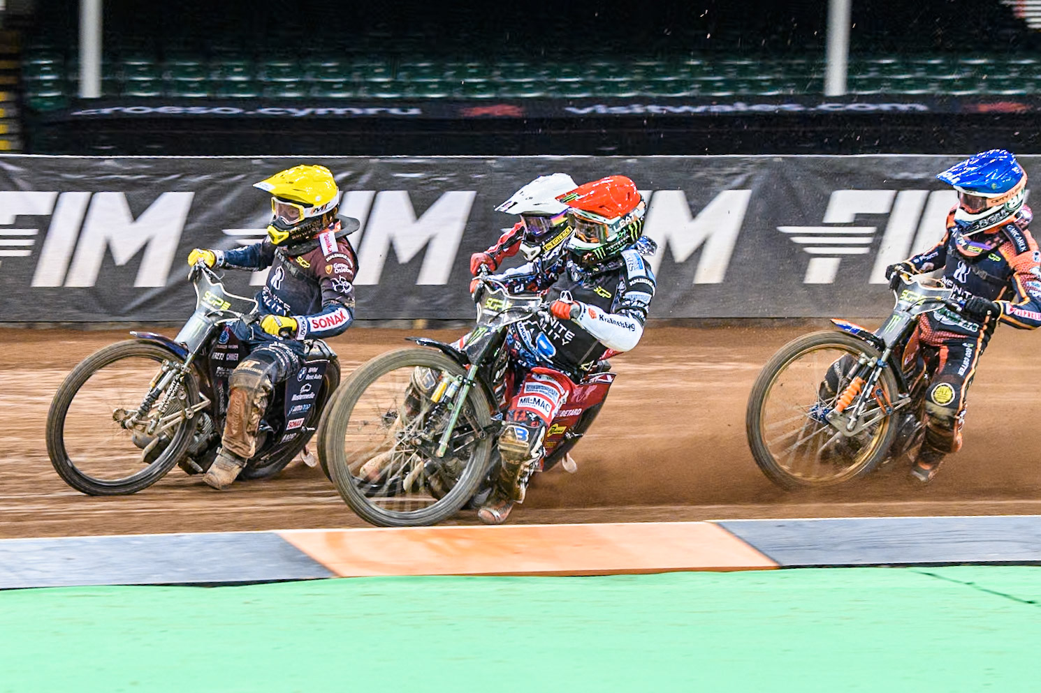 Fredrik Lindgren (66) of Sweden in Red rides inside \46\ in White and Dominik Kubera (415) of Poland in Yellow with Mikkel Michelsen (155) of Denmark in Blue behind during the FIM Speedway Grand Prix of Great Britain at The Principality Stadium, Cardiff on Saturday 17th August 2024. (Photo: Ian Charles | MI News)