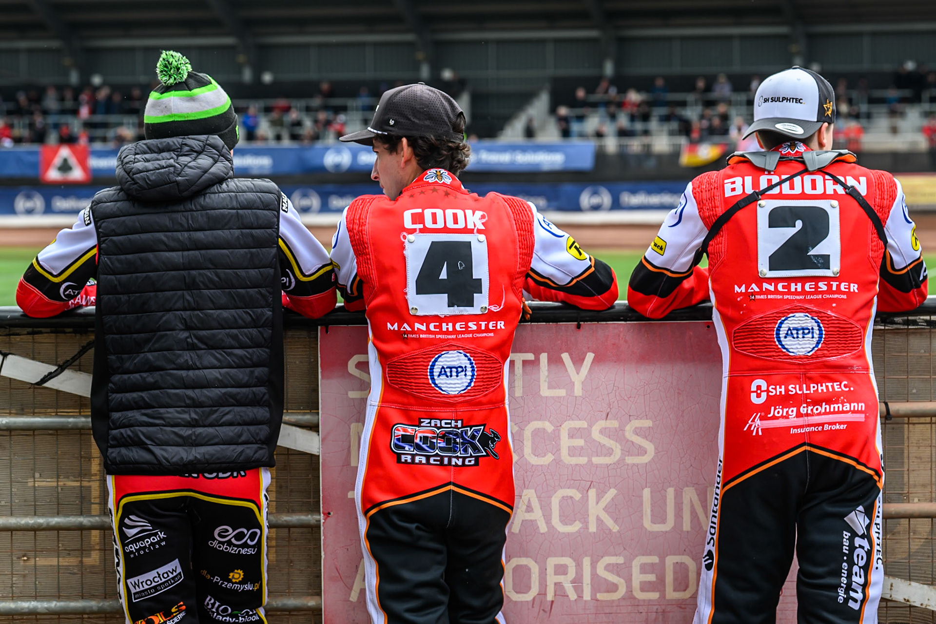 (L to R) Belle Vue Aces' Dan Bewley, Belle Vue Aces' Zach Cook, and Belle Vue Aces' Norick Blödorn watch the track prep during the Rowe Motor Oil Premiership match between Belle Vue Aces and Oxford Spires at the National Speedway Stadium, Manchester on Monday 26th May 2025. (Photo: Ian Charles | MI News)