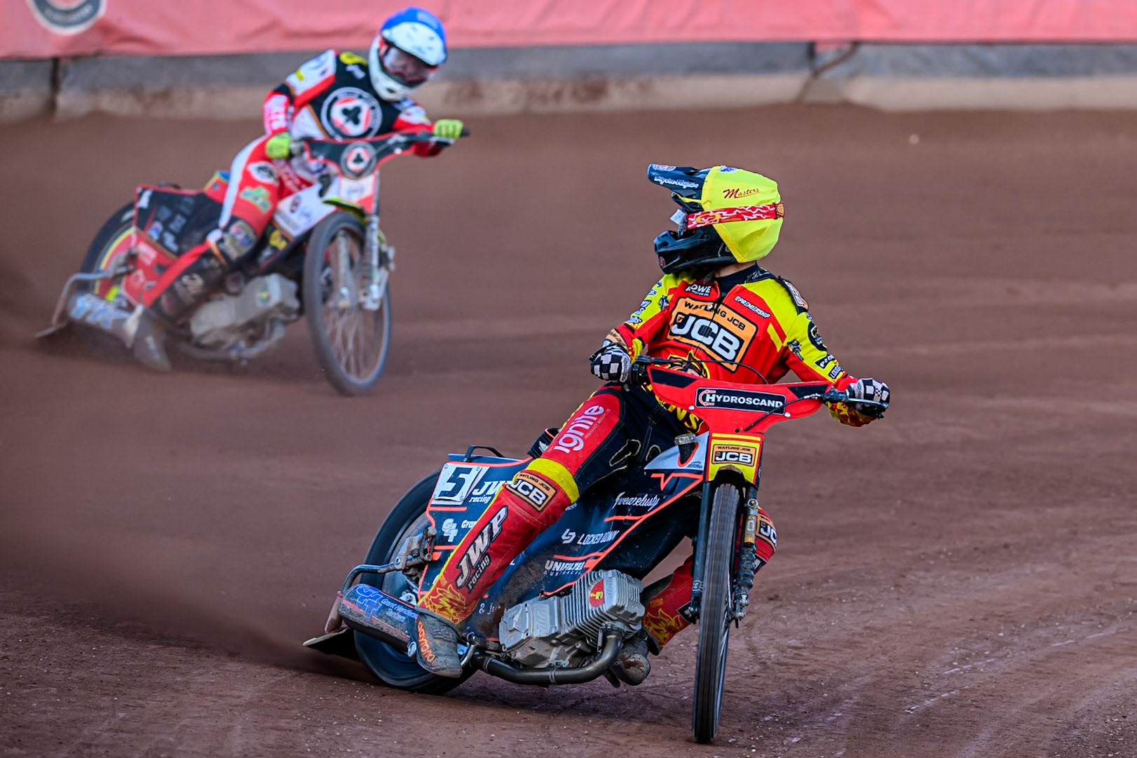 Leicester Lions' Sam Masters  in Yellow looks for Belle Vue Aces' Tate Zischke in Blue during the Rowe Motor Oil Premiership match between Belle Vue Aces and Leicester Lions at the National Speedway Stadium, Manchester on Monday 14th July 2025. (Photo: Ian Charles | MI News)