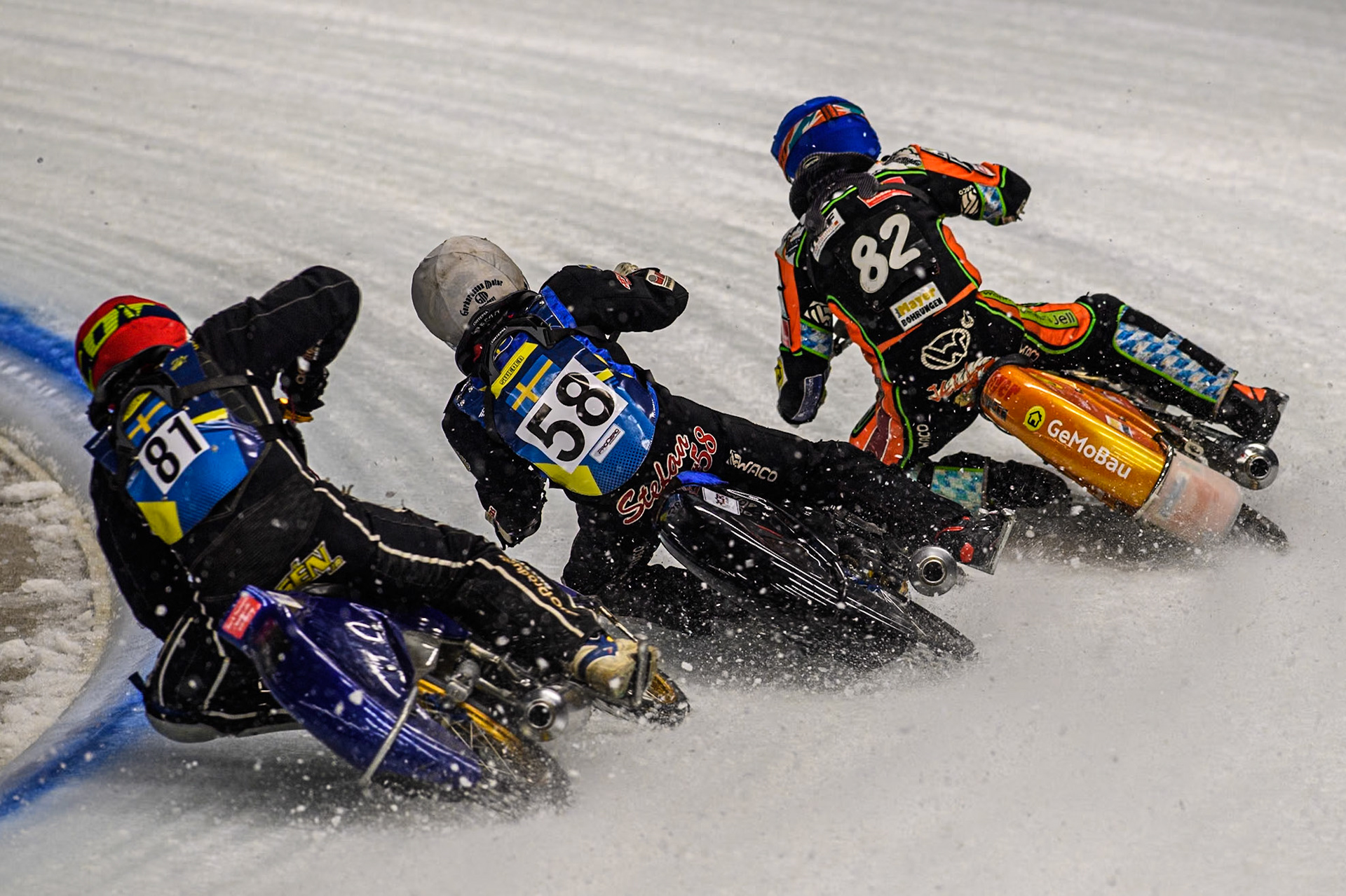 Sweden"s Jimmy Olsén (81) (Red) chases Sweden's Stefan Svensson (58) \’w\ and Germany's Markus Jell (82) (Blue) during the FIM Ice Speedway Gladiators World Championship Final 1 at the Max-Aicher-Arena, Inzell on Saturday 23 March 2024. (Photo: Ian Charles | MI News)