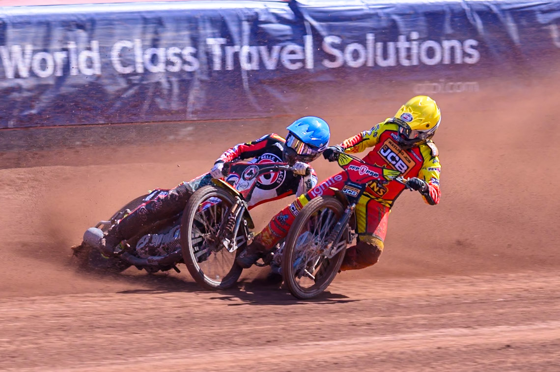 Kyle Howarth of Leicester Lions  in Yellow brings down Tate Zischke of Belle Vue Aces in Blue during the Knockout Cup Northern Section match between Belle Vue Aces and Leicester Lions at the National Speedway Stadium, Manchester on Monday 6th April 2026. (Photo: Ian Charles | MI News)