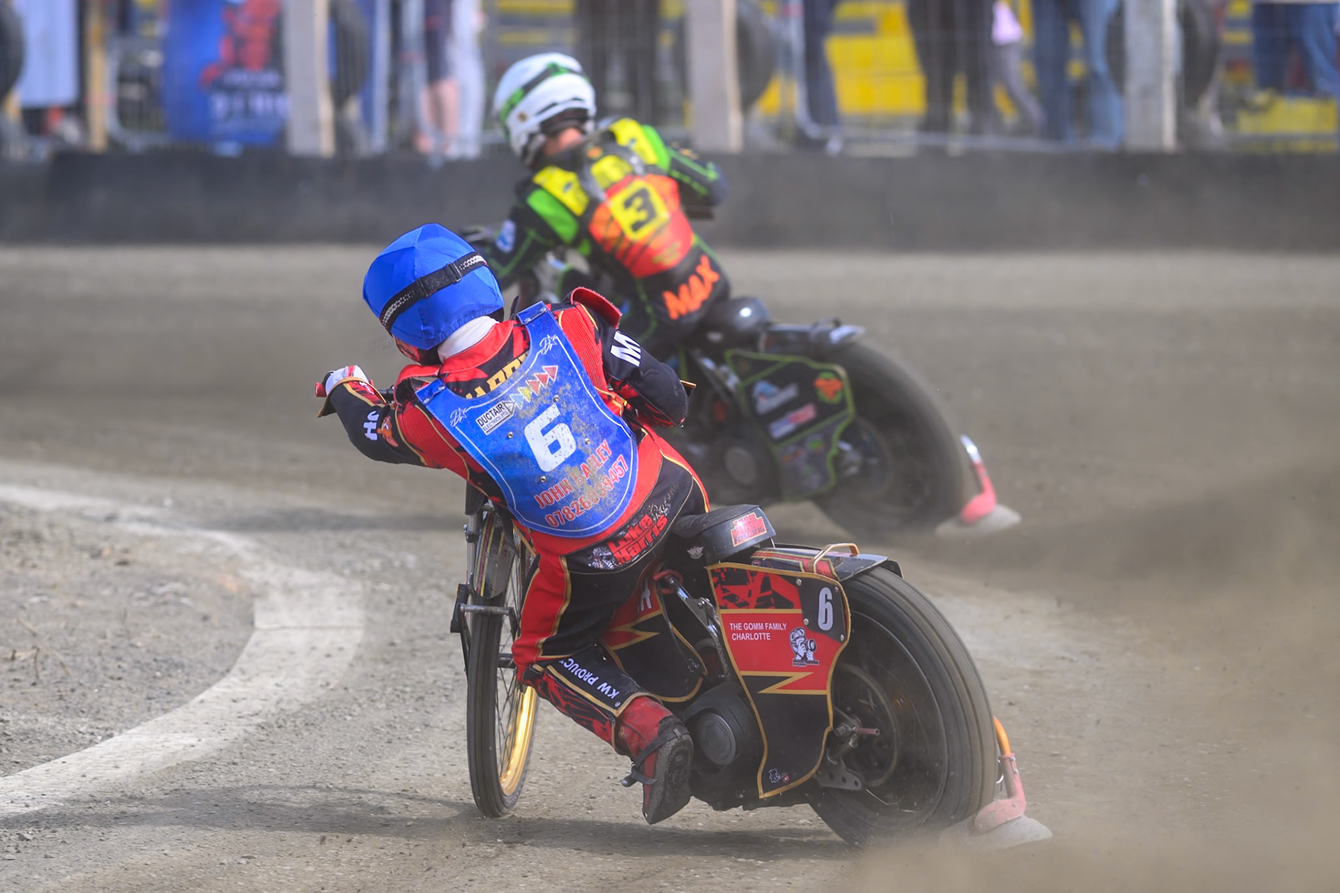 Luke Harris of Buxton Bulls  in Blue chases Max Perry of Leicester Lion Cubs  in White during the Challenge match between Buxton Bulls and Leicester Lion Cubs at Hi-Edge Speedway, Buxton on Sunday 26th April 2026. (Photo: Ian Charles | MI News)
