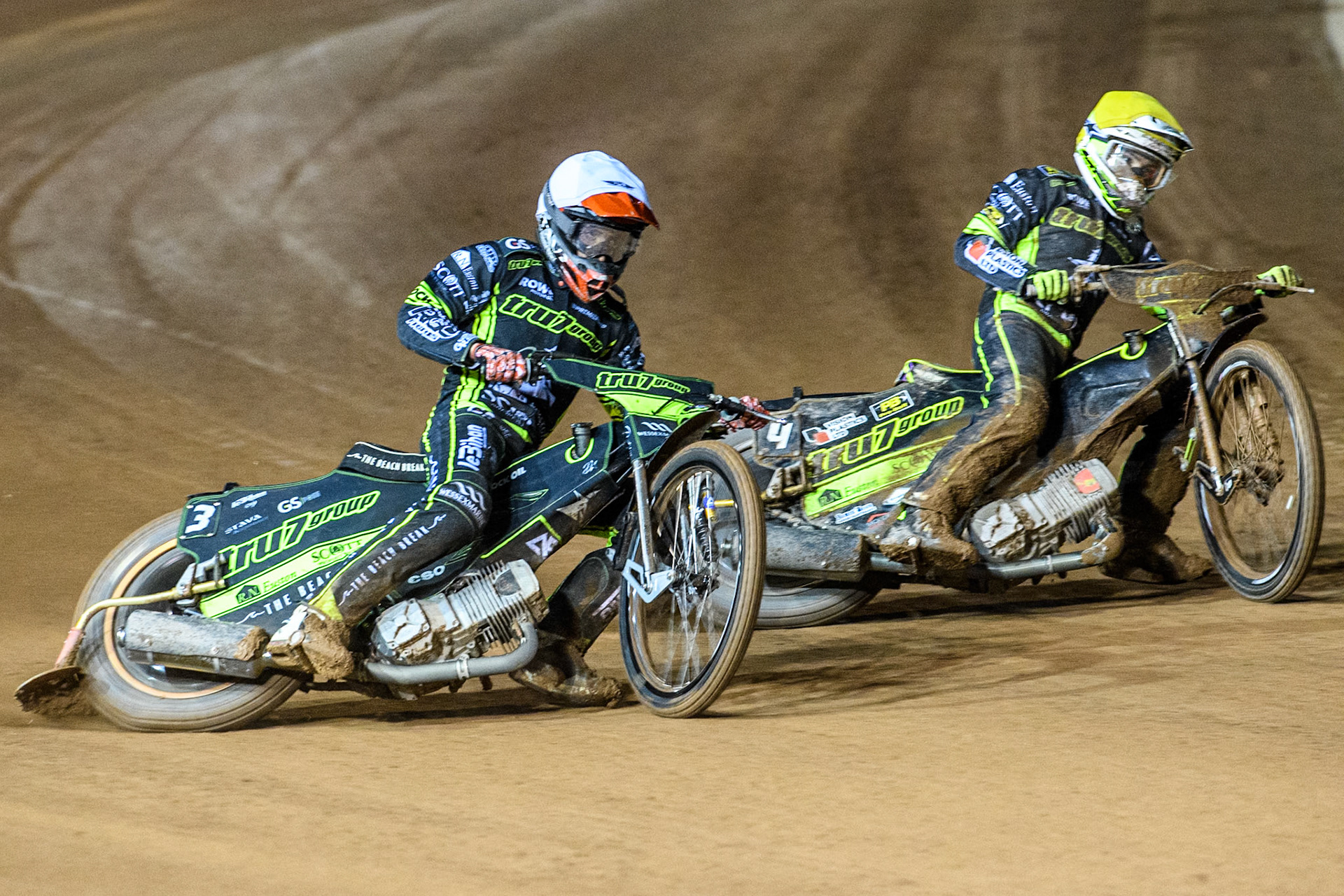 Adam Ellis of Ipswich Witches in White rides outside Tom Brennan of Ipswich Witches in Yellow during the Premiership Cup Quarter Final 1st Leg match between Belle Vue Aces and Ipswich Witches at the National Speedway Stadium, Manchester on Monday 24th March 2025. (Photo: Ian Charles | MI News)