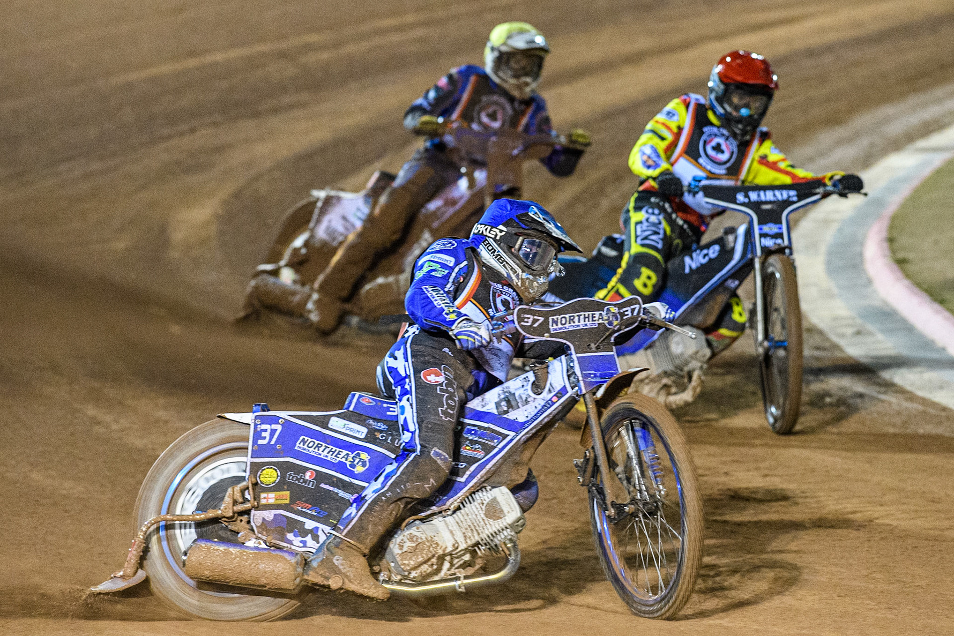 Chris Harris in Blue leading Chris Harris in Red and Niels-Kristian Iversen in Yellow during the Peter Craven Memorial Trophy at the National Speedway Stadium, Manchester on Monday 17th March 2025. (Photo: Ian Charles | MI News)