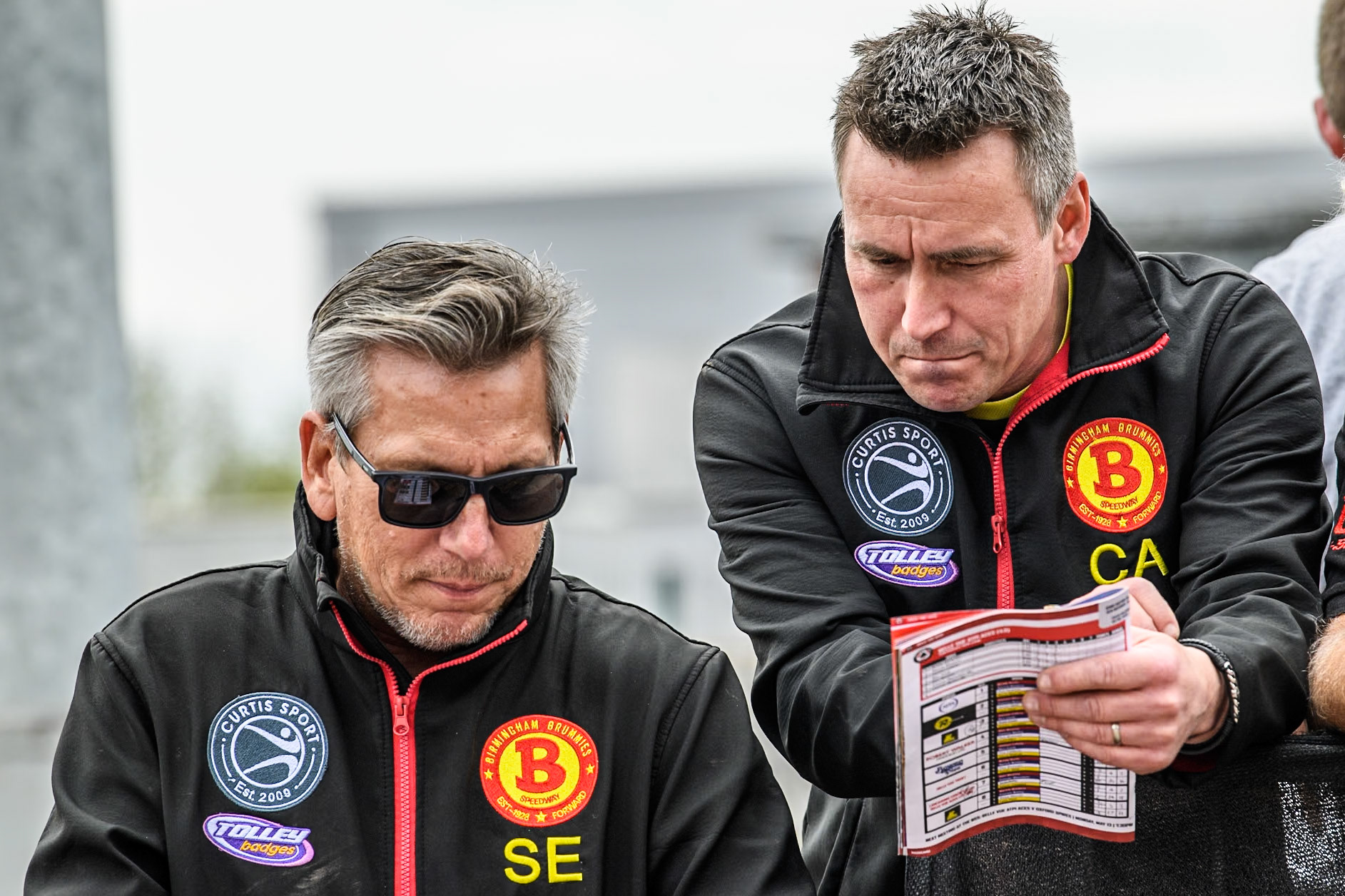 Birmingham Brummies' Team Manager Sam Ermolenko  (Left) and Birmingham Brummies' Assistant Team Manager Chris Adams plan their next move during the Rowe Motor Oil Premiership match between Belle Vue Aces and Birmingham Brummies at the National Speedway Stadium, Manchester on Monday 6th May 2024. (Photo: Ian Charles | MI News)