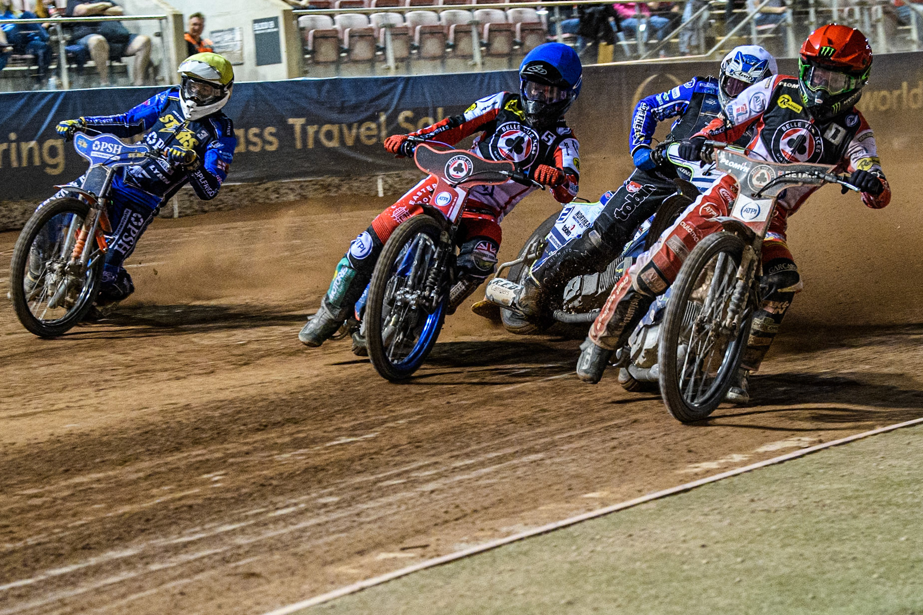 Belle Vue Aces' Dan Bewley  in Red and Belle Vue Aces' Brady Kurtz  in Blue leading Kings Lynn Stars' Guest Rider Chris Harris  in White and Kings Lynn Stars' Niels-Kristian Iversen  in Yellow during the Rowe Motor Oil Premiership match between Belle Vue Aces and King's Lynn Stars at the National Speedway Stadium, Manchester on Monday 12th August 2024. (Photo: Ian Charles | MI News)