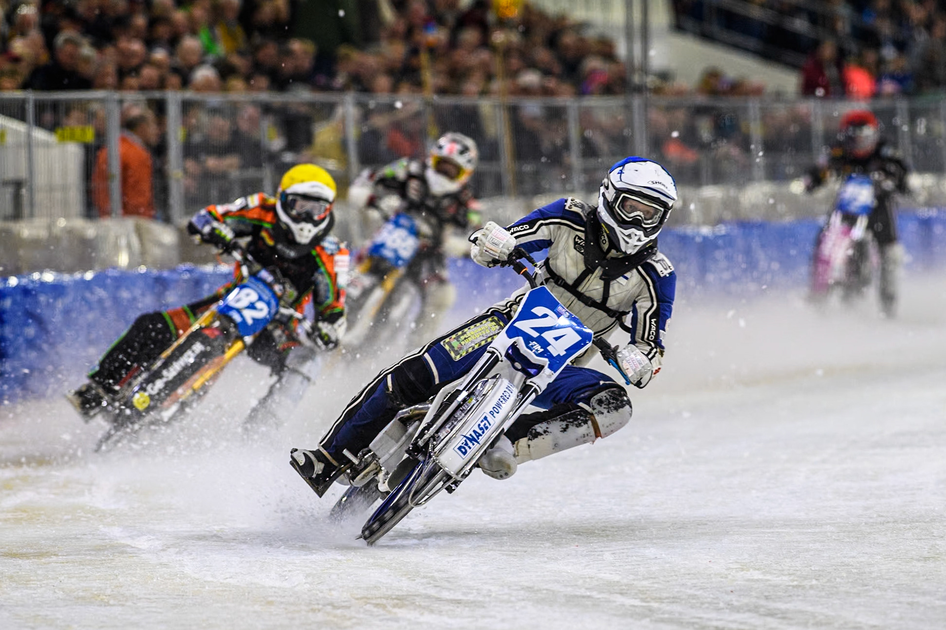 Finland's Max Koivula (24) in Blue leading  Germany's Markus Jell (82) in Yellow and Austria's Charly Ebner (665) in White with Germany's Benedikt Monn (99) in Red behind during the FIM Ice Speedway Gladiators World Championship Final 3 at Ice Rink Thialf, Heerenveen on Saturday 6th April 2024. (Photo: Ian Charles | MI News)