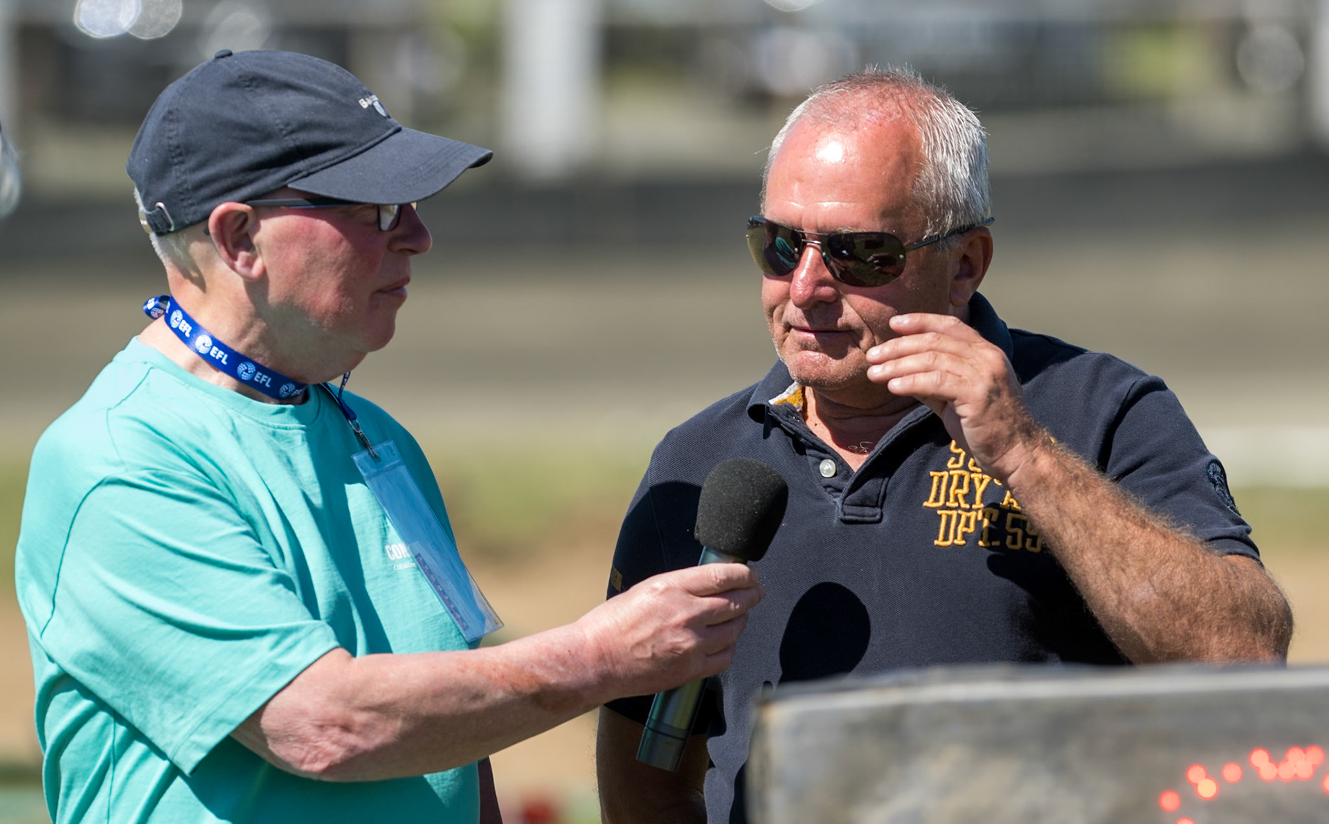 Buxton Speedway Presenter Dave Stringer (Left) interviews Nigel Crabtree, Team Manager of Stoke Potters, a former Stoke rider, during the National Development League Challenge match between Buxton Bulls and Stoke Potters at Hi-Edge Speedway, Buxton on Sunday 24th May 2026. (Photo: Ian Charles | MI News)
