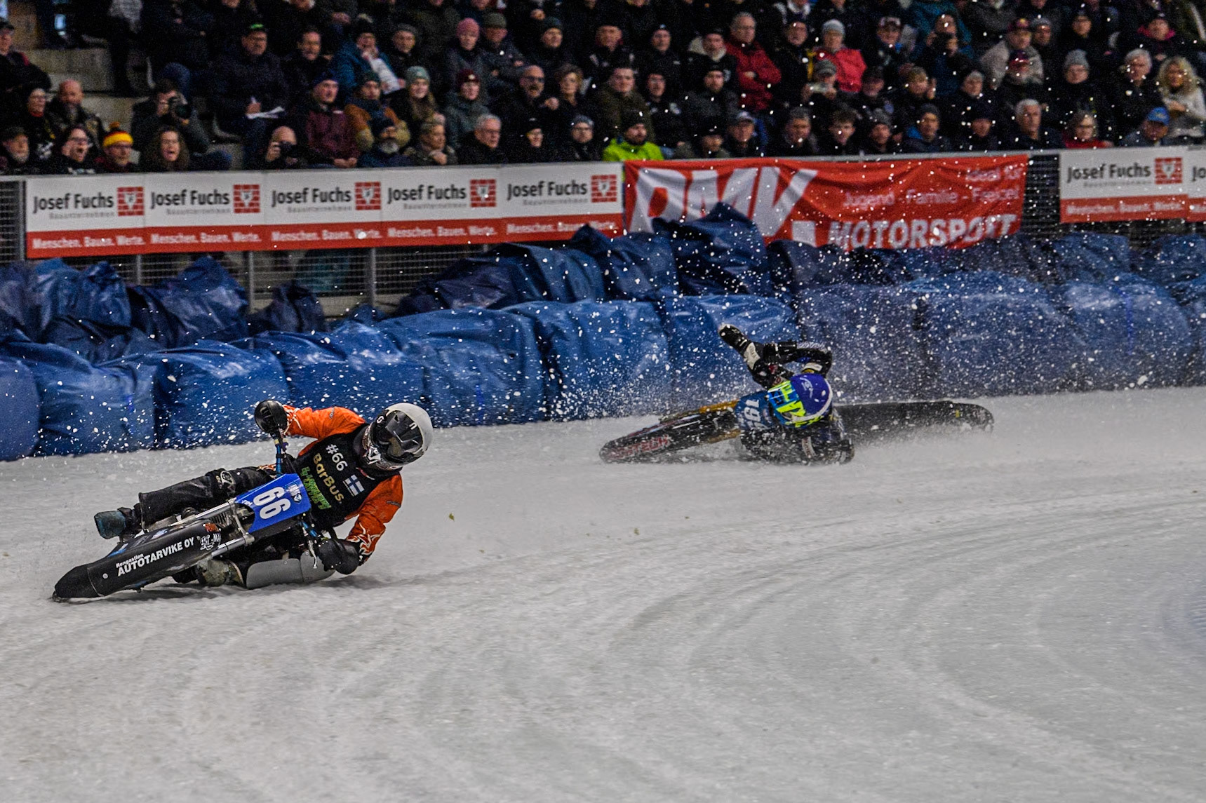 Finland's Aki Ala-Riihimäki (66) (White) leads  as Sweden's Martin Haarahiltunen (199)  (Blue) crashes out during the FIM Ice Speedway Gladiators World Championship Final 2 at the Max-Aicher-Arena, Inzell on Sunday 24 March 2024. (Photo: Ian Charles | MI News)