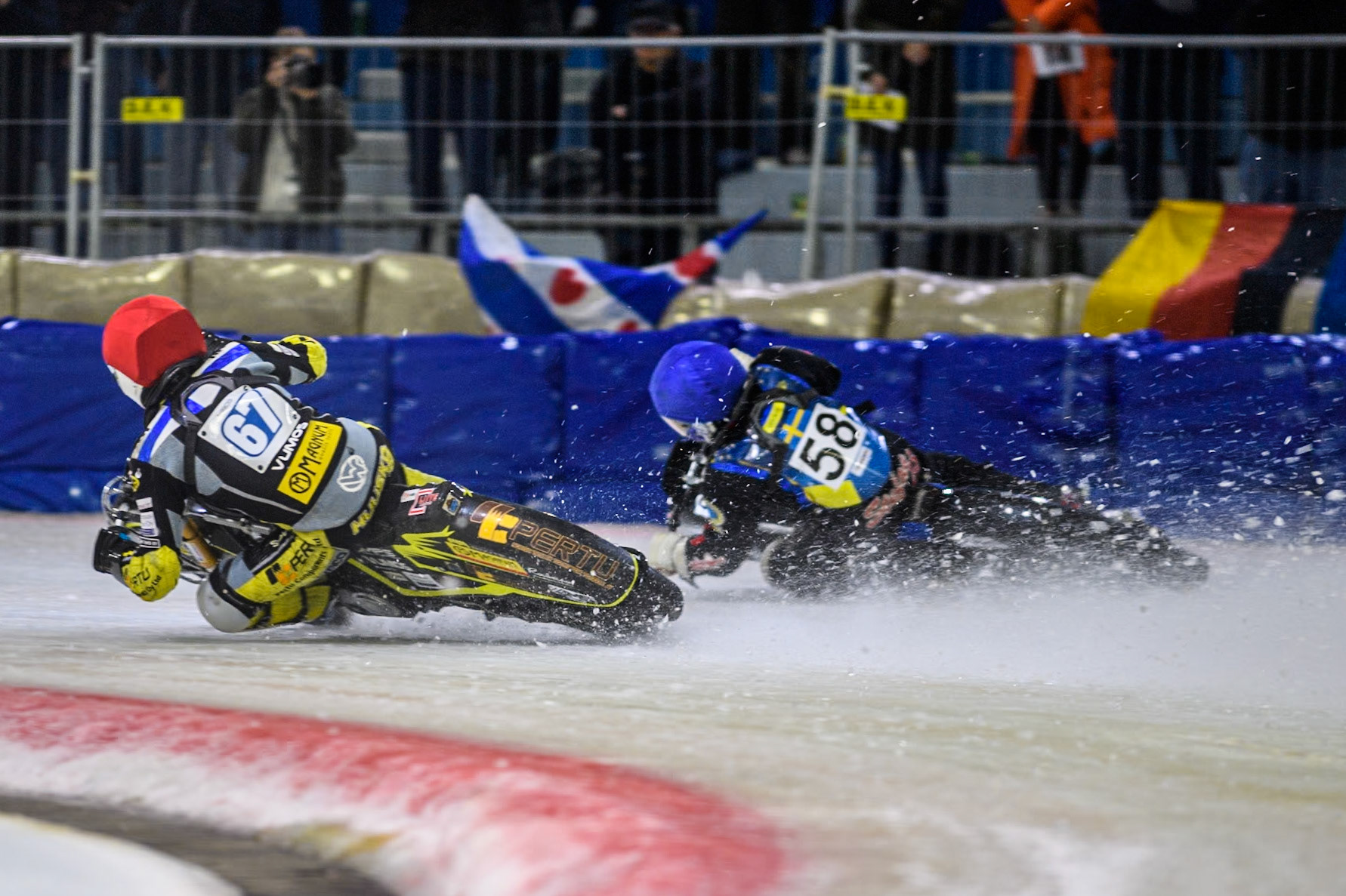 Finland's Heikki Huusko (67) in Red passes Sweden's Stefan Svensson (58) in Blue during the FIM Ice Speedway Gladiators World Championship Final 4 at Ice Rink Thialf, Heerenveen on Sunday 7th April 2024. (Photo: Ian Charles | MI News)