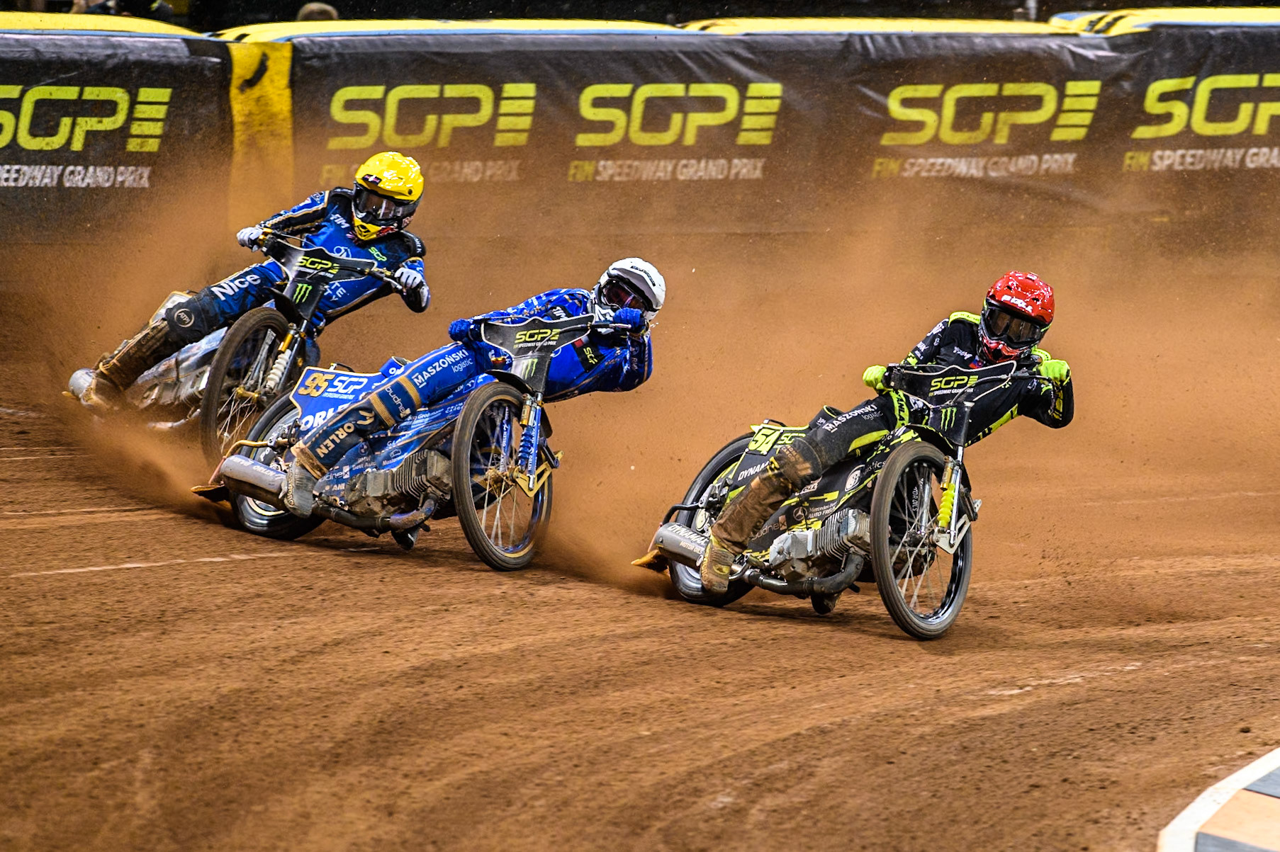 Martin Vaculik (54) of Slovakia in Red rides inside Bartosz Zmarzlik (95) of Poland  in White and Robert Lambert (505) of Great Britain in Yellow during the FIM Speedway Grand Prix of Great Britain at The Principality Stadium, Cardiff on Saturday 17th August 2024. (Photo: Ian Charles | MI News)