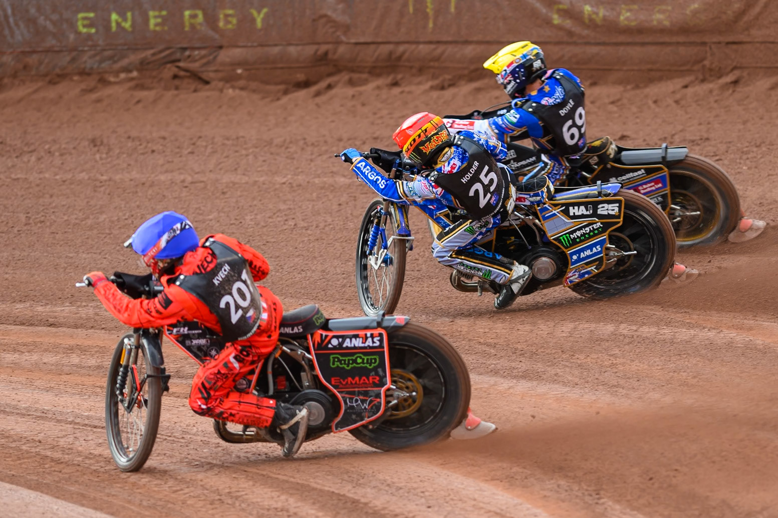 Jan Kvech (201) of Czech Republic in Blueon the inside of Jack Holder (25) of Australia in Red and Jason Doyle (69) of Australia in Yellow during the ATPI  FIM Speedway GP of Manchester at the National Speedway Stadium, Manchester on Saturday 6th June 2026. (Photo: Ian Charles | MI News)