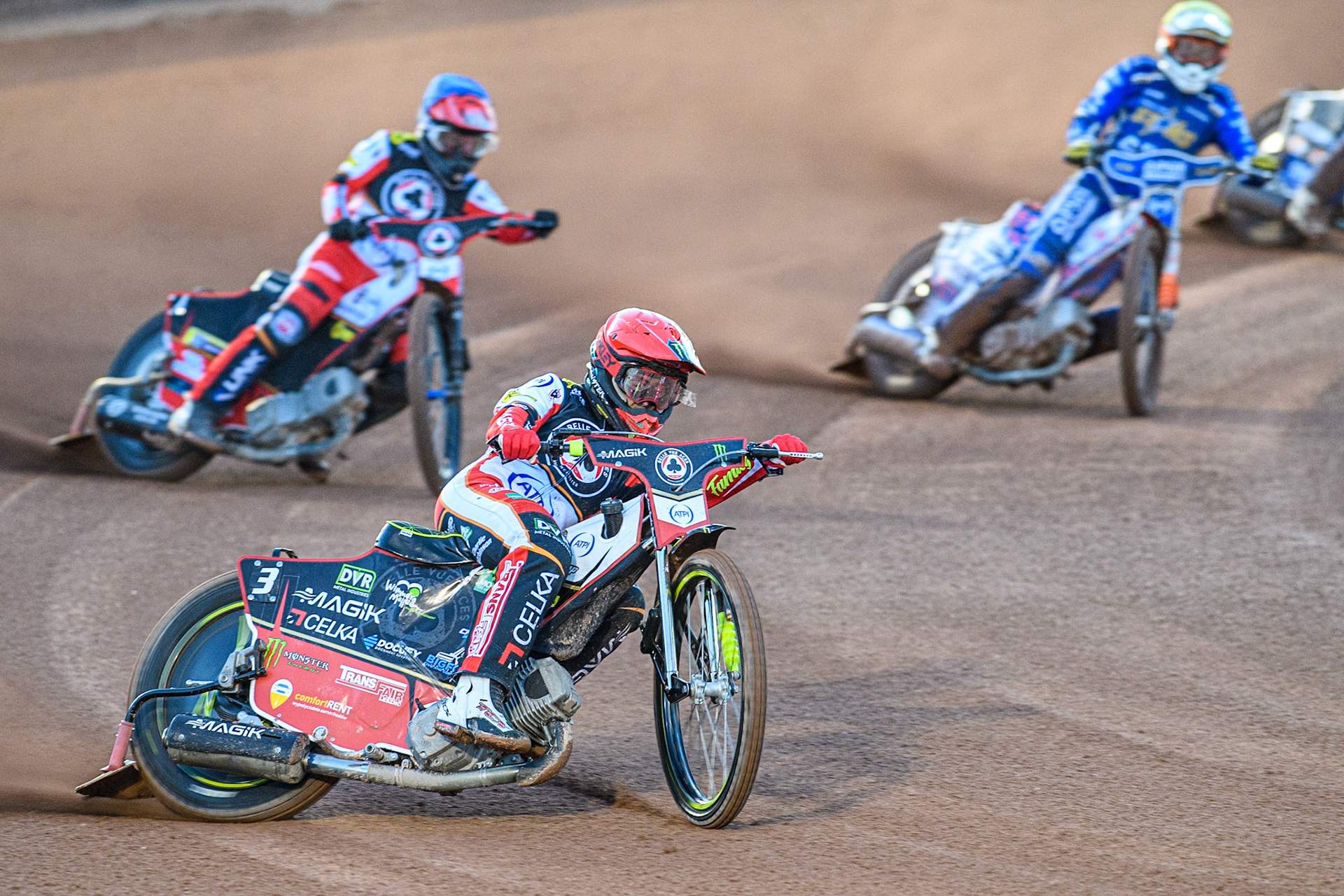 Jaimon Lidsey of Belle Vue Aces in Red leading Zach Cook of Belle Vue Aces in Blue and Nicolai Klindt of Kings Lynn Stars in White during the Rowe Motor Oil Premiership match between Belle Vue Aces and King's Lynn Stars at the National Speedway Stadium, Manchester on Monday 5th April 2025. (Photo: Ian Charles | MI News)