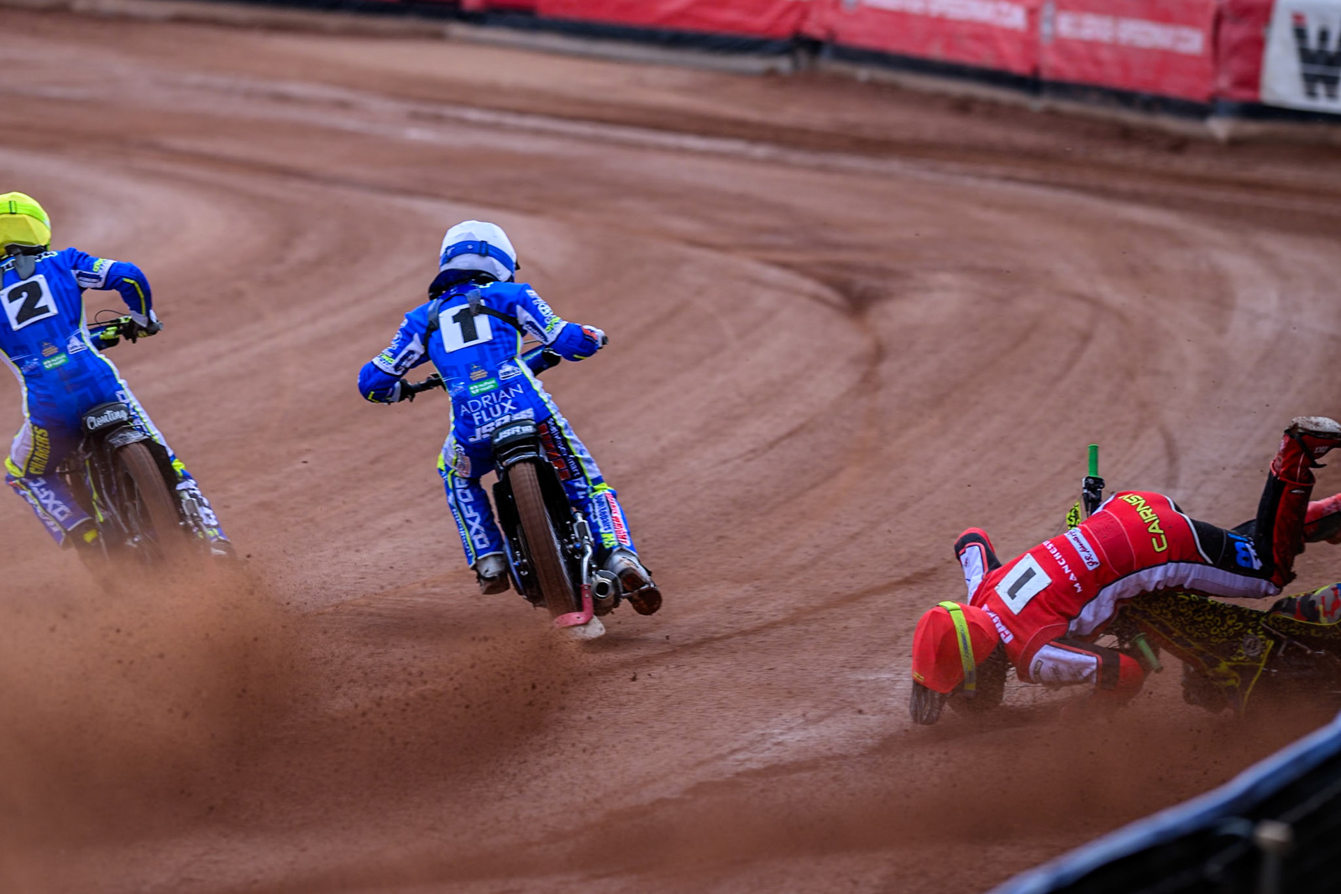 Belle Vue Colts' William Cairns falls whilst trying to pass Oxford Chargers' Jody Scott  in White and Oxford Chargers' Jacob Clouting  in Yellow during the WSRA National Development League match between Belle Vue Colts and Oxford Chargers at the National Speedway Stadium, Manchester on Sunday 1st June 2025. (Photo: Ian Charles | MI News)