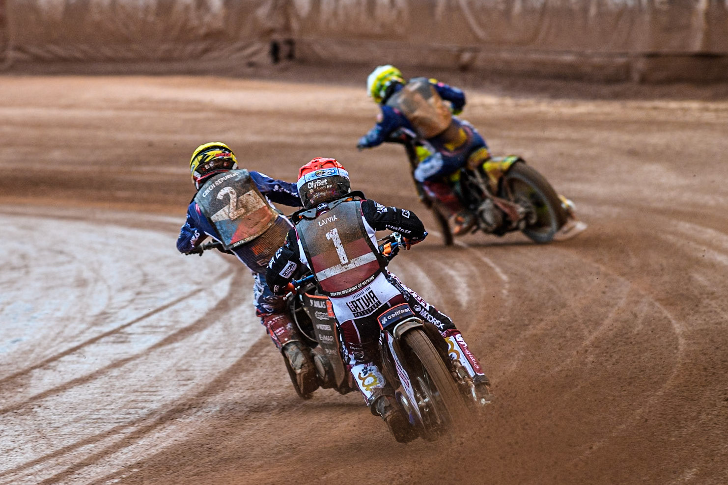 Andzejs Lebedevs of Latvia in Red chases Jan Kvech of The Czech Republic in Yellow and Vaclav Milik of The Czech Republic in White during the Monster Energy FIM Speedway of Nation Semi Final 2 at the National Speedway Stadium, Manchester on Wednesday 10th July 2024. (Photo: Ian Charles | MI News)