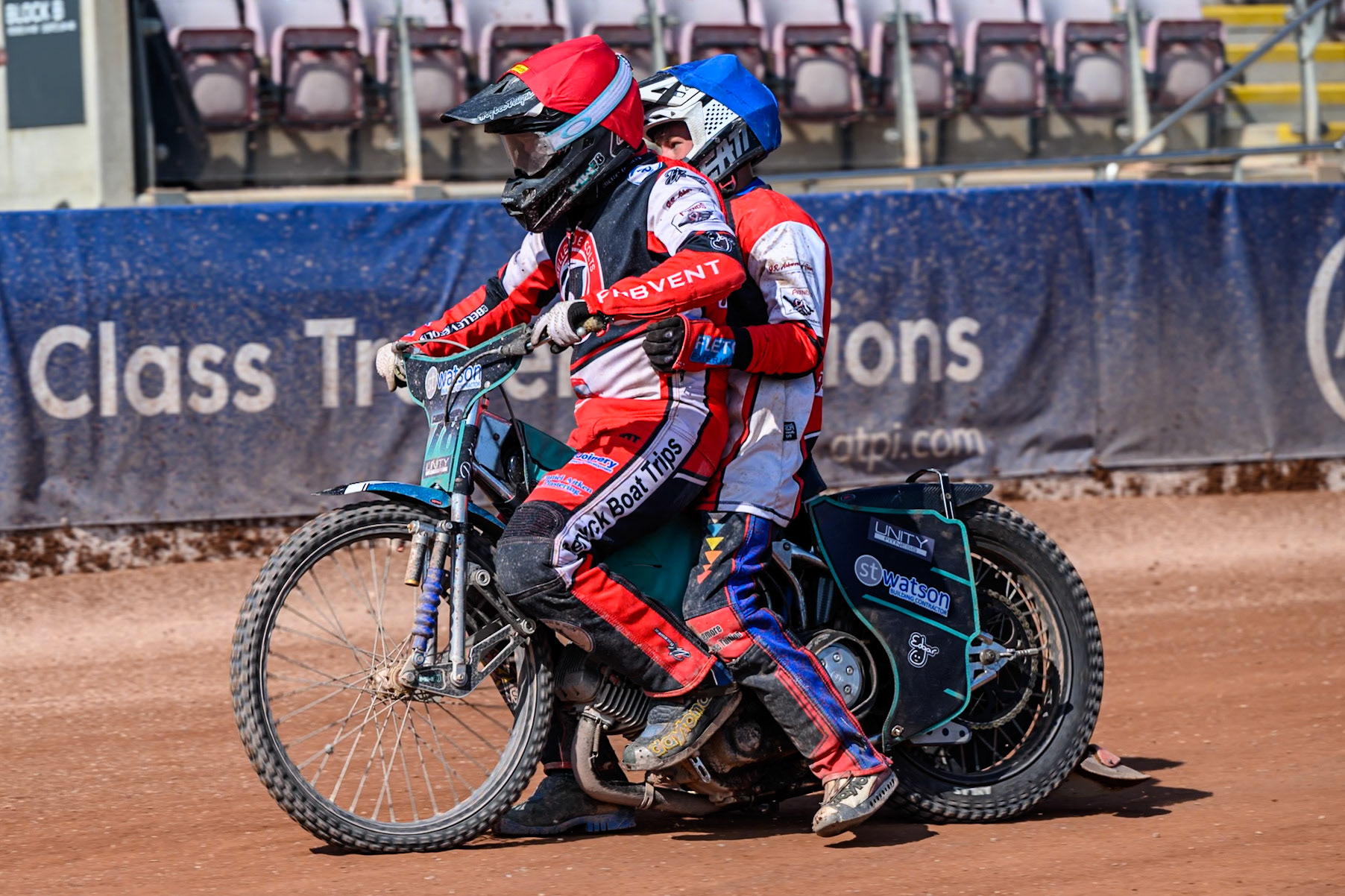 Mason Watson of Belle Vue Colts  in Red gives team mate Harry Fletcher a lift back to the pits after Fletcher’s  machine failedduring the WSRA National Development League match between Belle Vue Colts and Middlesbrough Tigers at the National Speedway Stadium, Manchester on Sunday 10th August 2025. (Photo: Mark Fletcher | MI News)