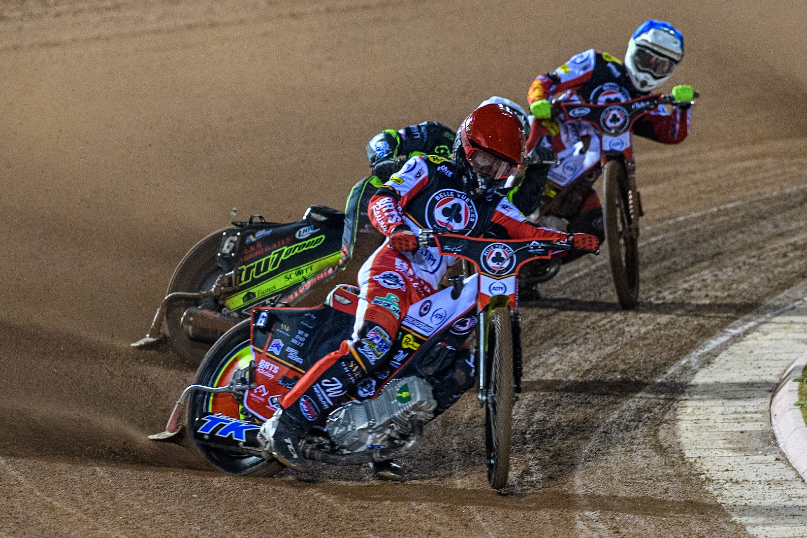Tate Zischke of Belle Vue Aces  in Red leading Dan Thompson of Ipswich Witches in White and Jake Mulford of Belle Vue Aces in Blue during the Premiership Cup Quarter Final 1st Leg match between Belle Vue Aces and Ipswich Witches at the National Speedway Stadium, Manchester on Monday 24th March 2025. (Photo: Ian Charles | MI News)