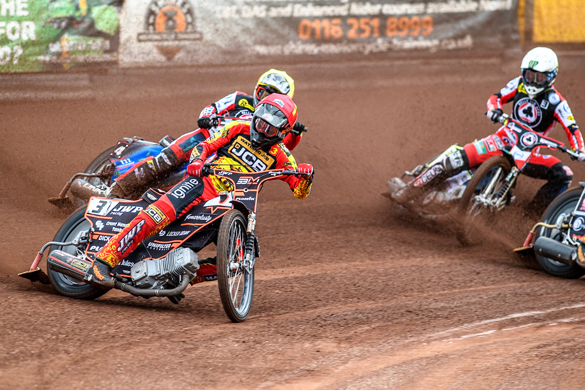 Leicester Lions' Sam Masters in Red leading Belle Vue Aces' Ben Cook in Yellow and Belle Vue Aces' Jaimon Lidsey in White during the Rowe Motor Oil Premiership match between Leicester Lions and Belle Vue Aces at the Pidcock Motorcycles Arena, Leicester on Thursday 25th July 2024. (Photo: Ian Charles | MI News)