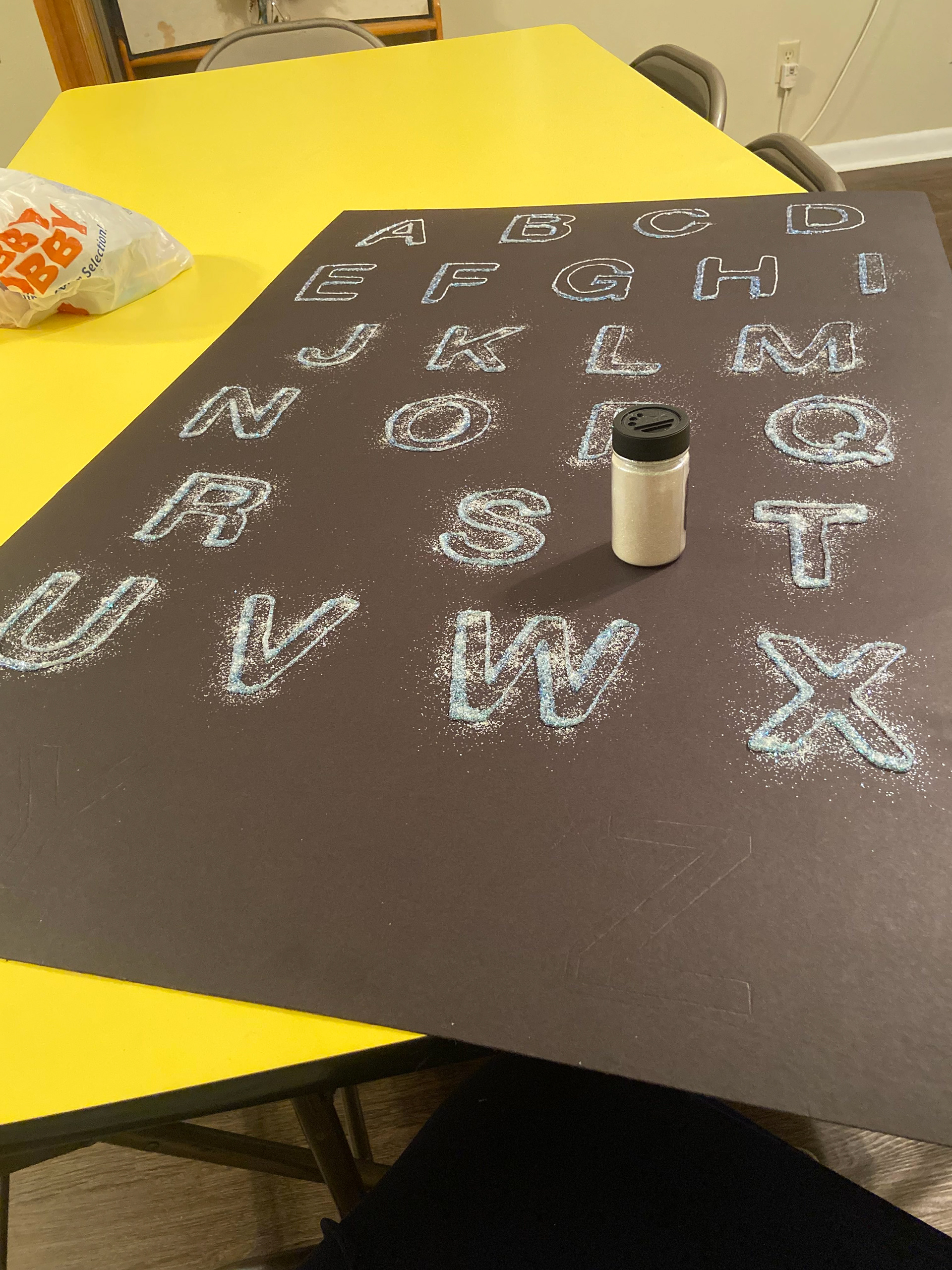 Progress of glue and glitter alphabet