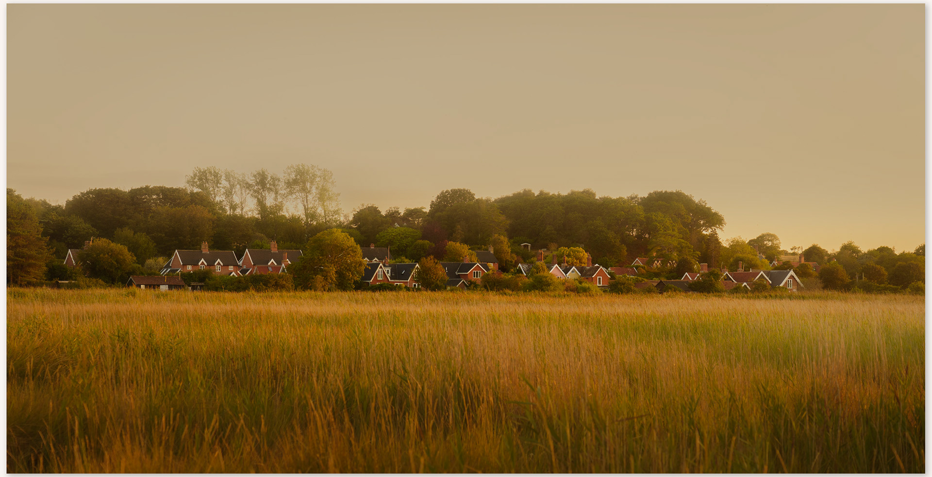 Dunwich village across the marshes at sunset