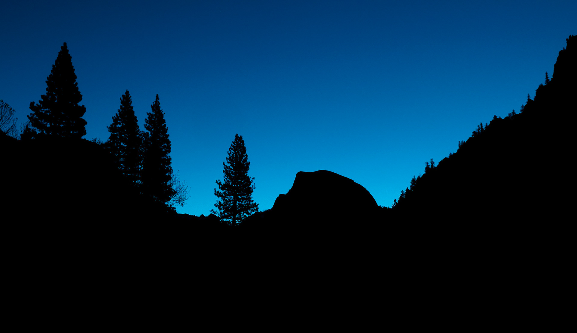 The iconic silhouette of Half Dome before dawn on a clear  fall morning.