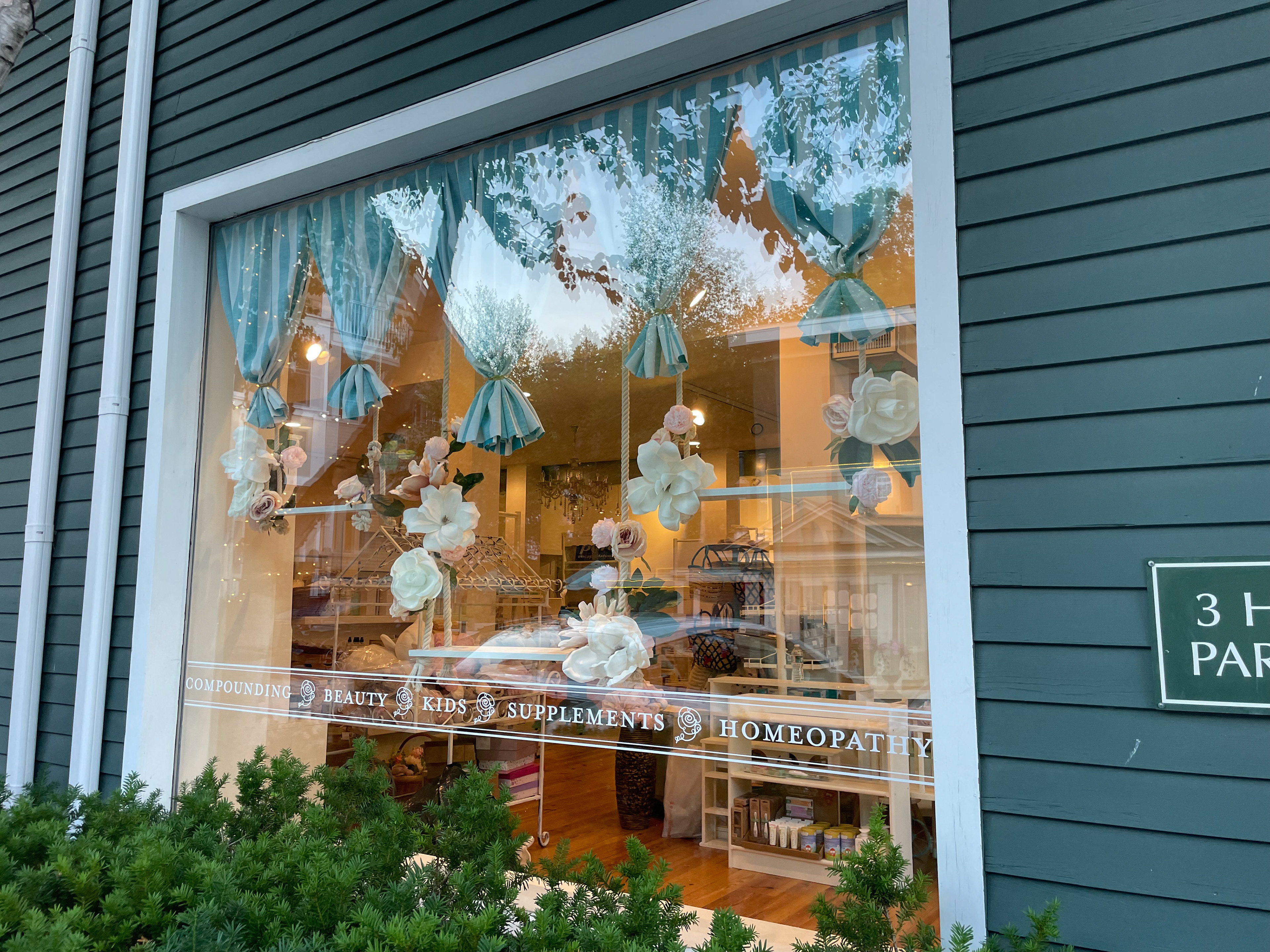 window display design including vinyl design, custom hanging shelves & textiles