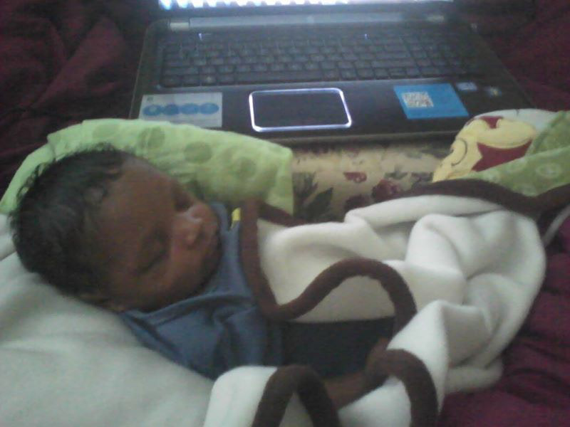 Mother Jakia Carroll Full-Time College Student in school while holding new born while he sleep