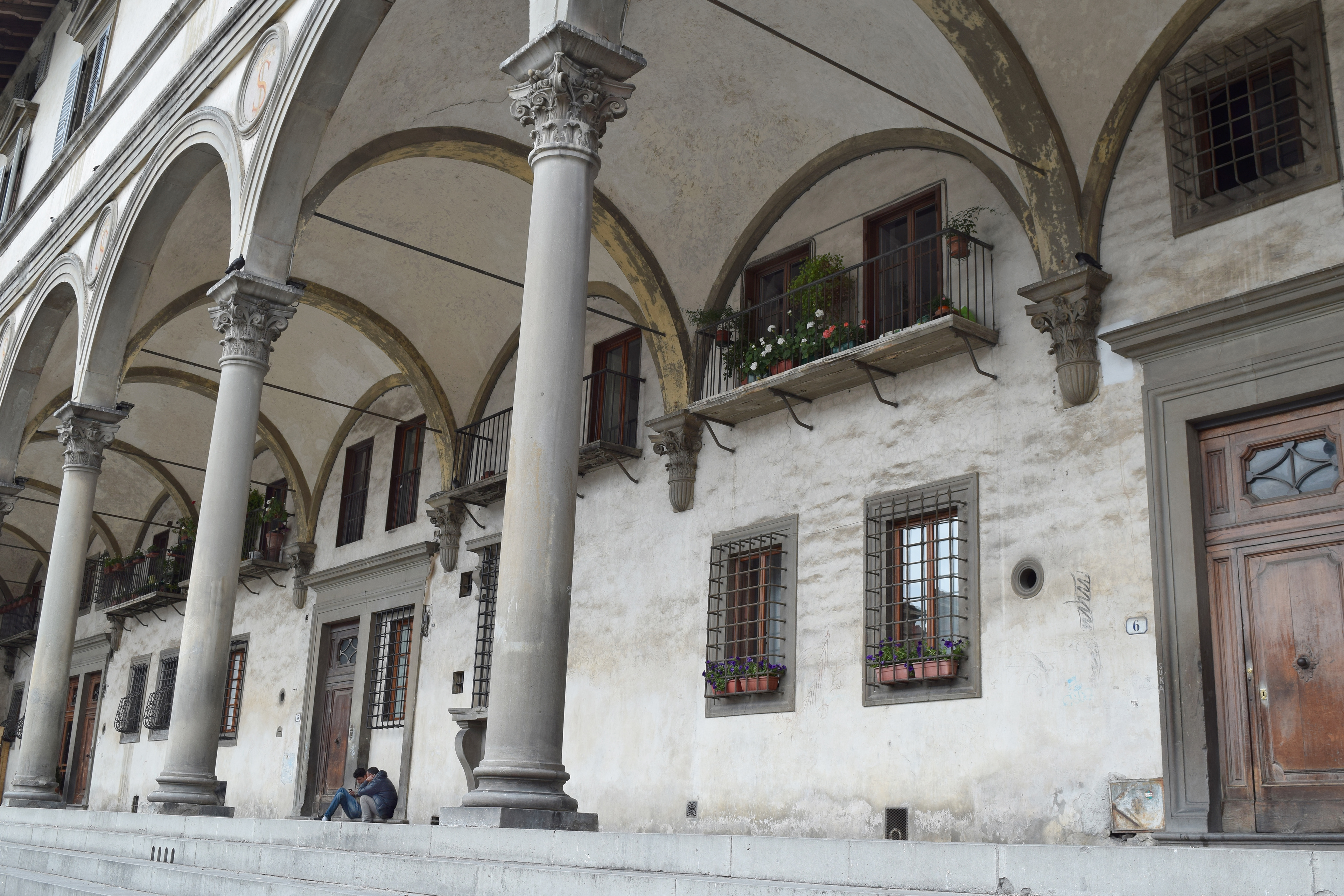 “It is beautiful here. Everyday, I walk under archways Michelangelo must have walked 500 years ago while he thought about painting and sculpting. I sit on steps Leonardo da Vinci surely sat on while sketching ideas way ahead of his time. I pass the house Dante Alighieri was born in 700 years ago. Dante invented the modern Italian language! I love Florentine history! But it makes me sad because I will never achieve those things. I will always sell sunglasses, or maybe if I am good enough, I can buy my own cart and sell leather bags. But I will never leave behind a legacy.” (Piazza della Santissima Annunziata, Florence, Italy)