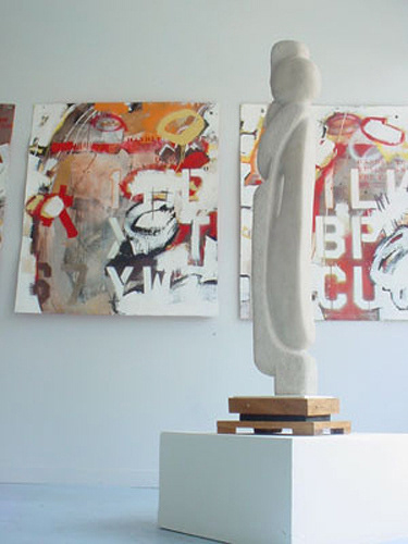 (behind sculpture by Jake Webster) Banner Series, acrylic, enamel, spraypaint and graphite on paper pulp, 40 x 72 inches, 2002