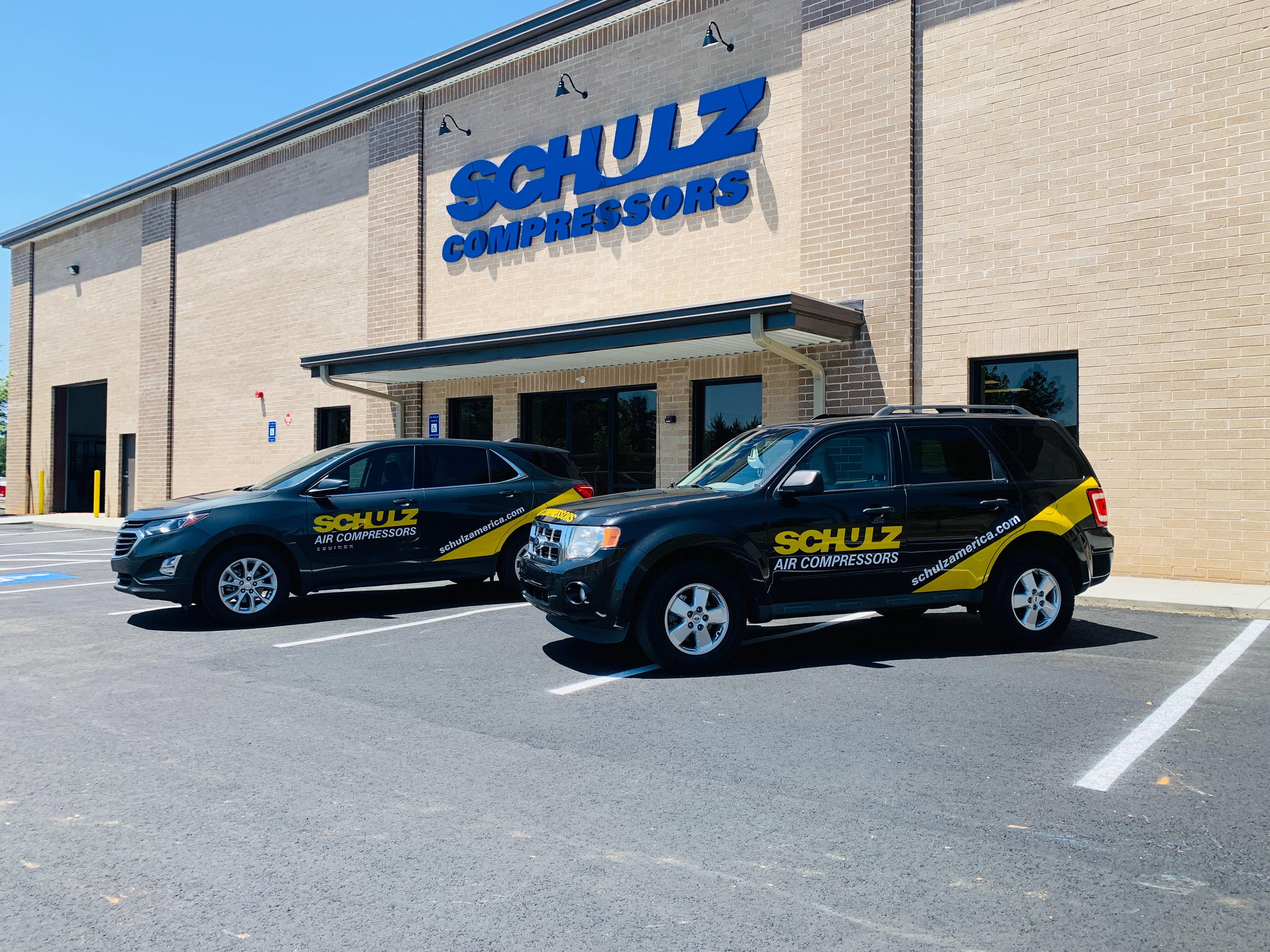 Atlanta branding project showing Schulz Compressors exterior sign and matching vehicle graphics for a complete commercial identity.