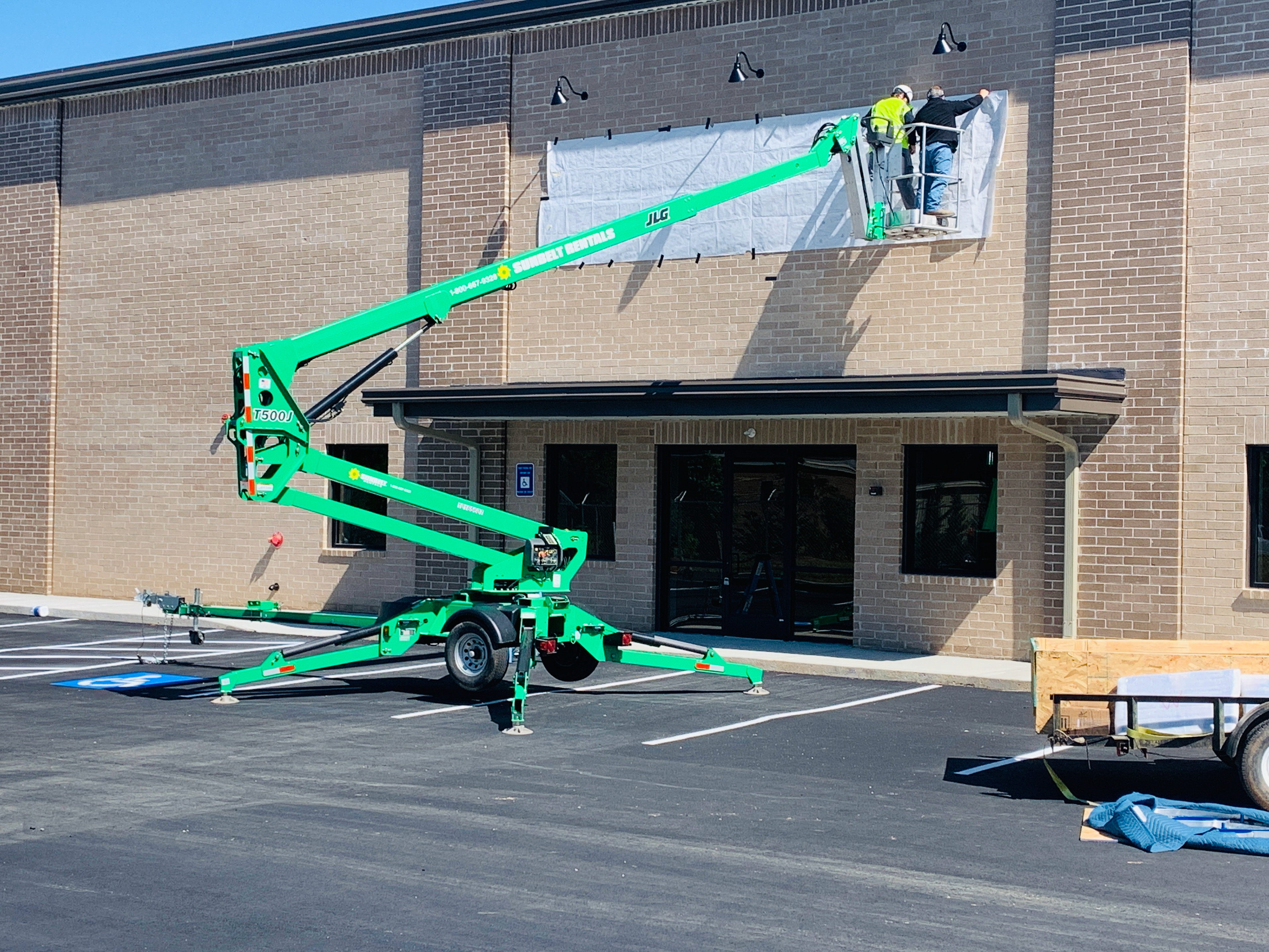 Commercial building sign installation in Atlanta using lift equipment for exterior dimensional signage and business branding.