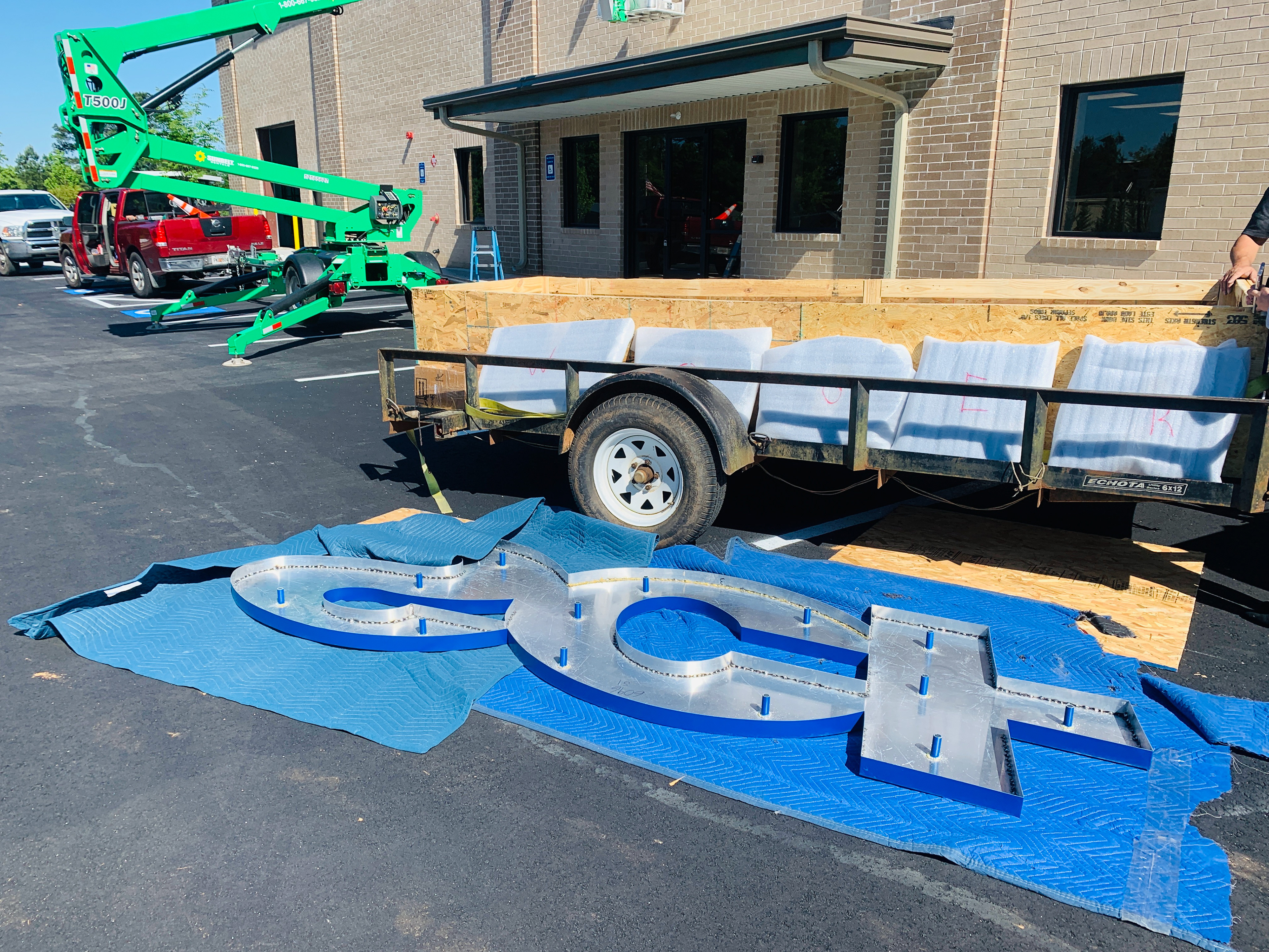 Commercial signage preparation showing dimensional sign letters before installation for an Atlanta-area branding project. This image represents graphic design, sign planning, dimensional signage, exterior business signs, large-format branding, and commercial graphics for companies in Atlanta, GA and Metro Atlanta.