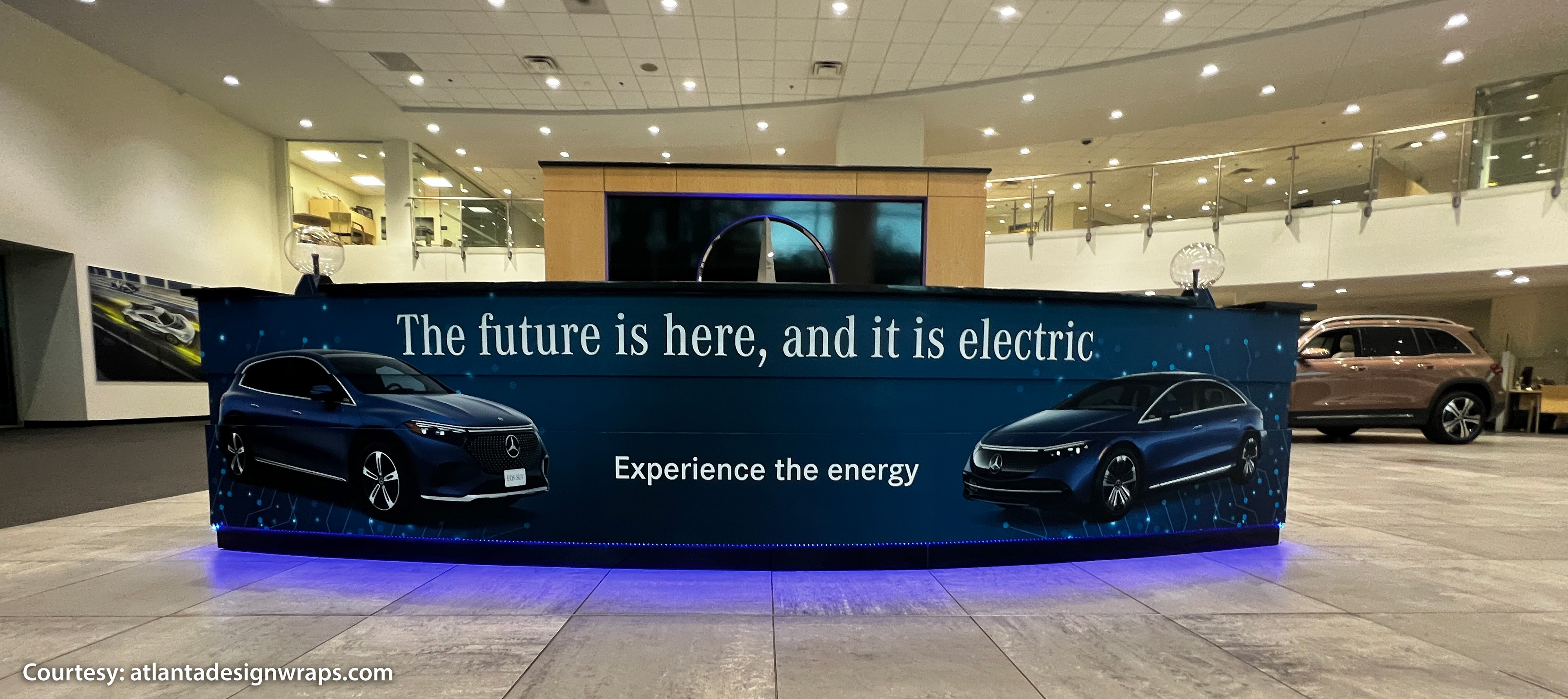 Curved electric vehicle showroom counter wrap designed, printed, and installed for Mercedes-Benz of Buckhead