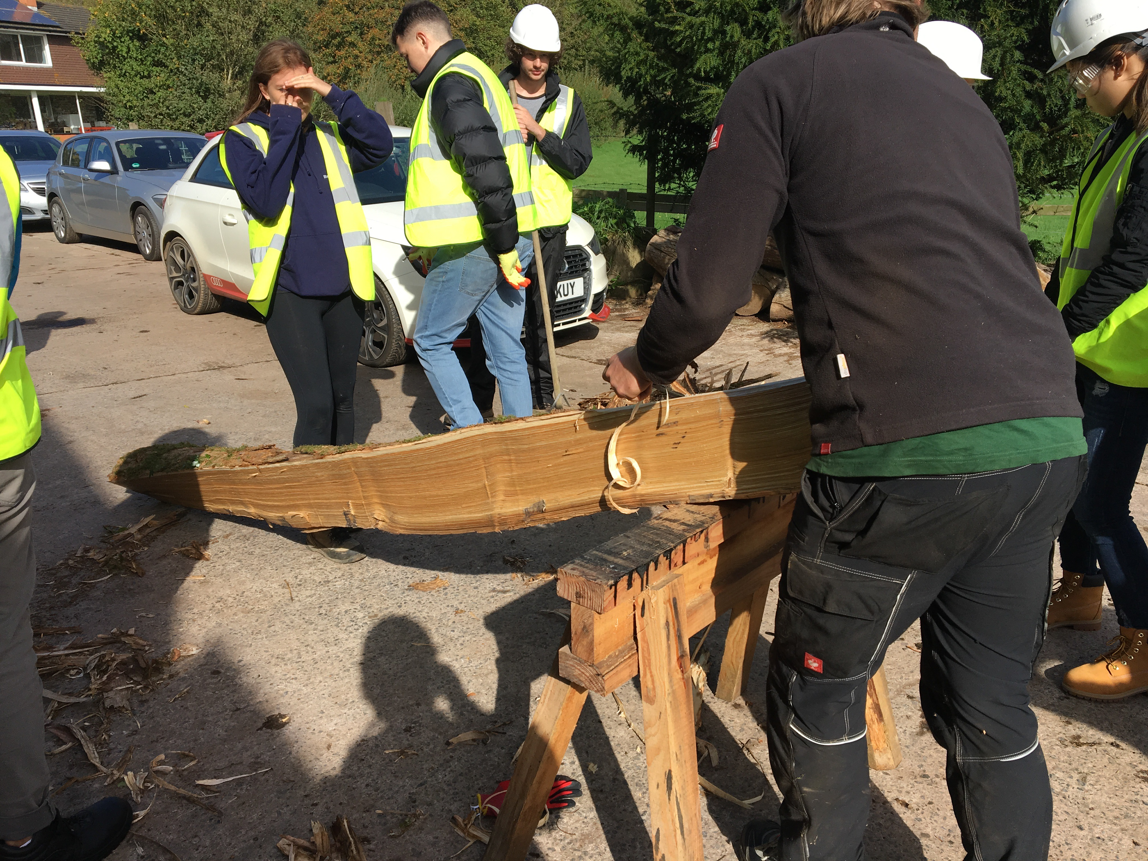 Shaving the timber stalks to be used for the foundation