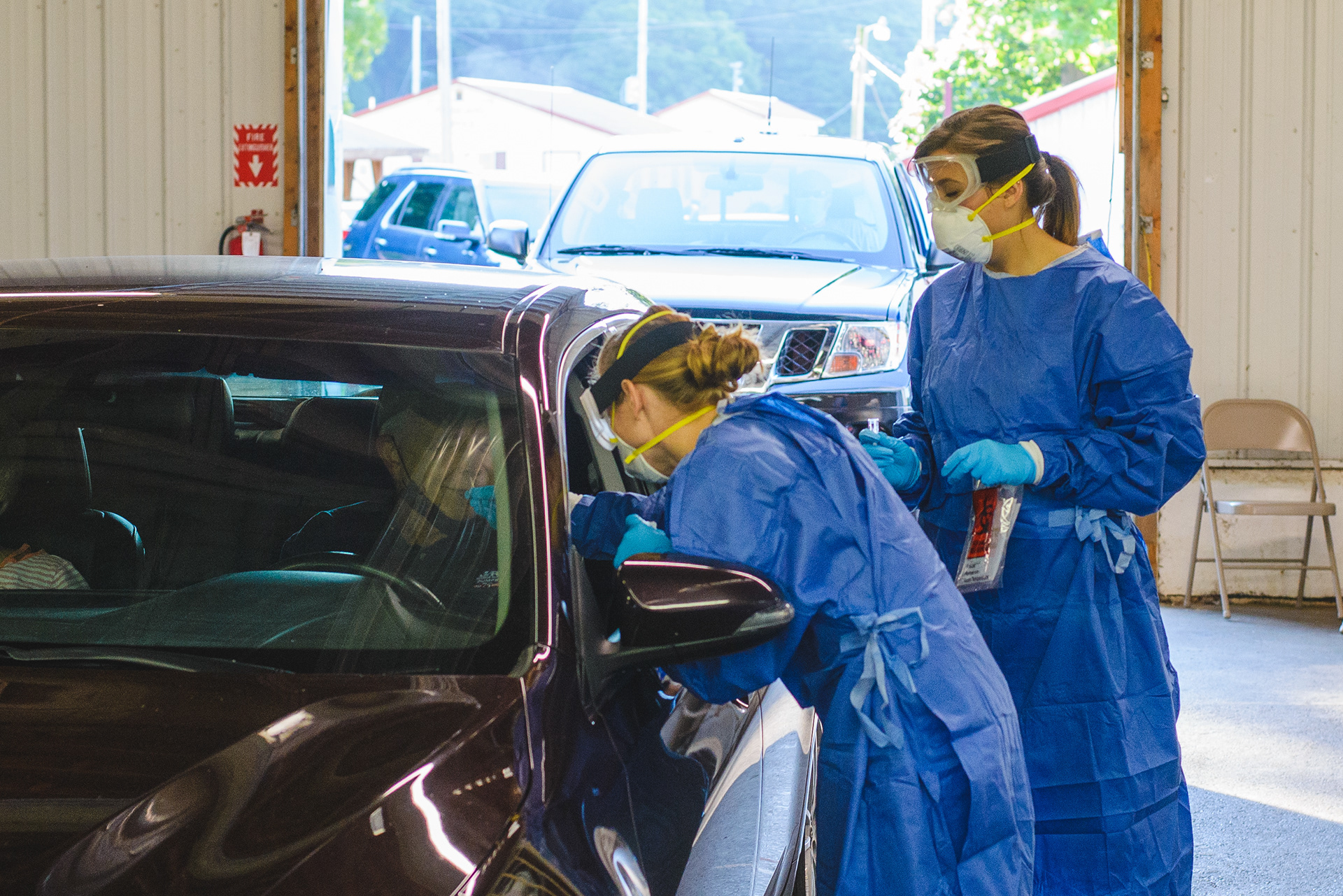Ohio National Guard specialists Courtney Murphy, left and Camilla Forbush conducts a swab test and specimen collection during a drive-thru COVID-19 test at the Knox County Fairgrounds on Saturday, August 8. No additional testing sites or dates have been announced for the remainder of August.