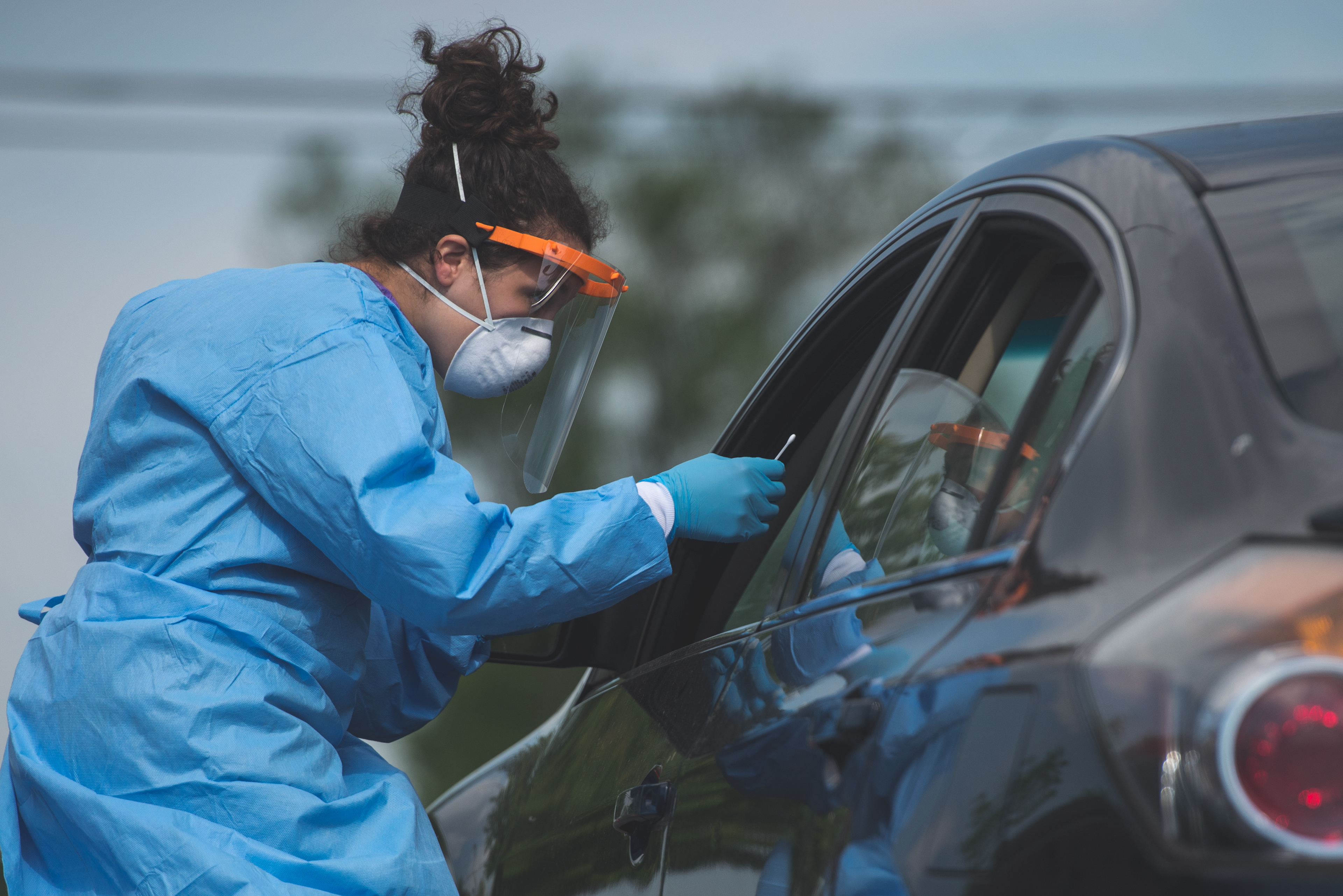 Knox Public Health’s Jenn Bohman prepares to administer a nasal swab during the drive-thru testing for COVID-19 Wednesday, June 3, 2020