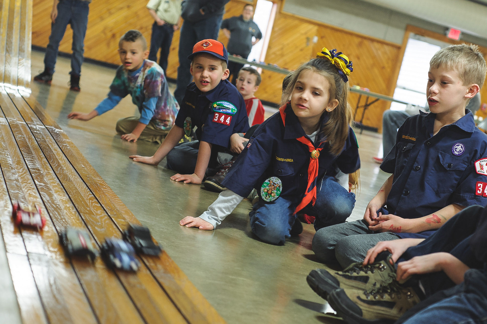 Pinewood Derby cars race down the track past, from left, Blake Cooper, Josh Westrick, Jordan Adams and Logan Miller. The Cub Scouts of America Pack 344 held their Pinewood Derby, Saturday, January 11, 2020 at the Floral Valley Community Center in Howard. The top finishers were David Swearingen in third, Daniel Adams finished second and Kolby Buckley was first.