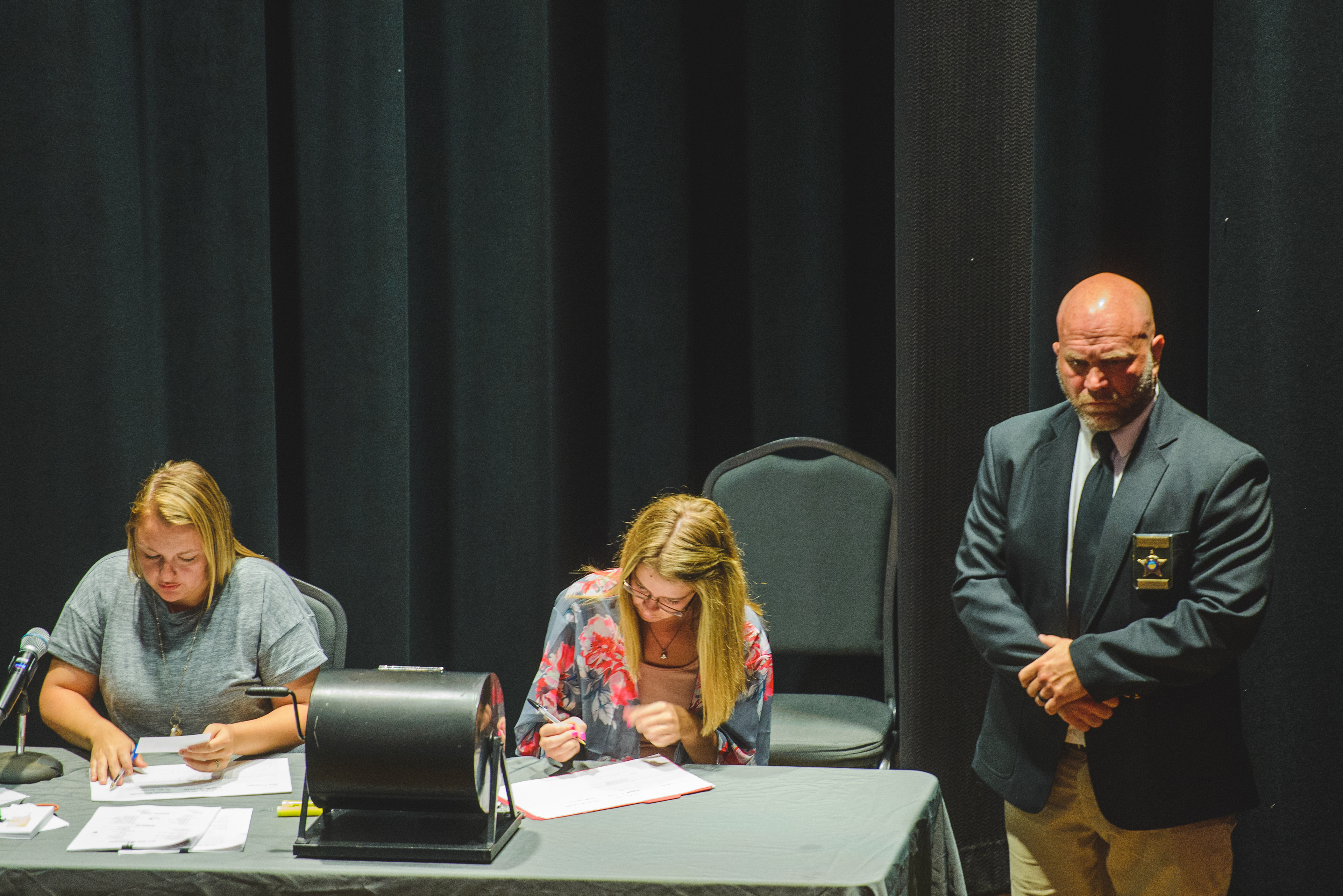 During the “voir dire” or jury selection process, court employees from left, Shelbi Robbins, Britney McNamara and court bailiff David Lashley would call for potential jurors from the stage of the Memorial Theater. The potential jurors would take questions from the judge and attorneys on the stage.